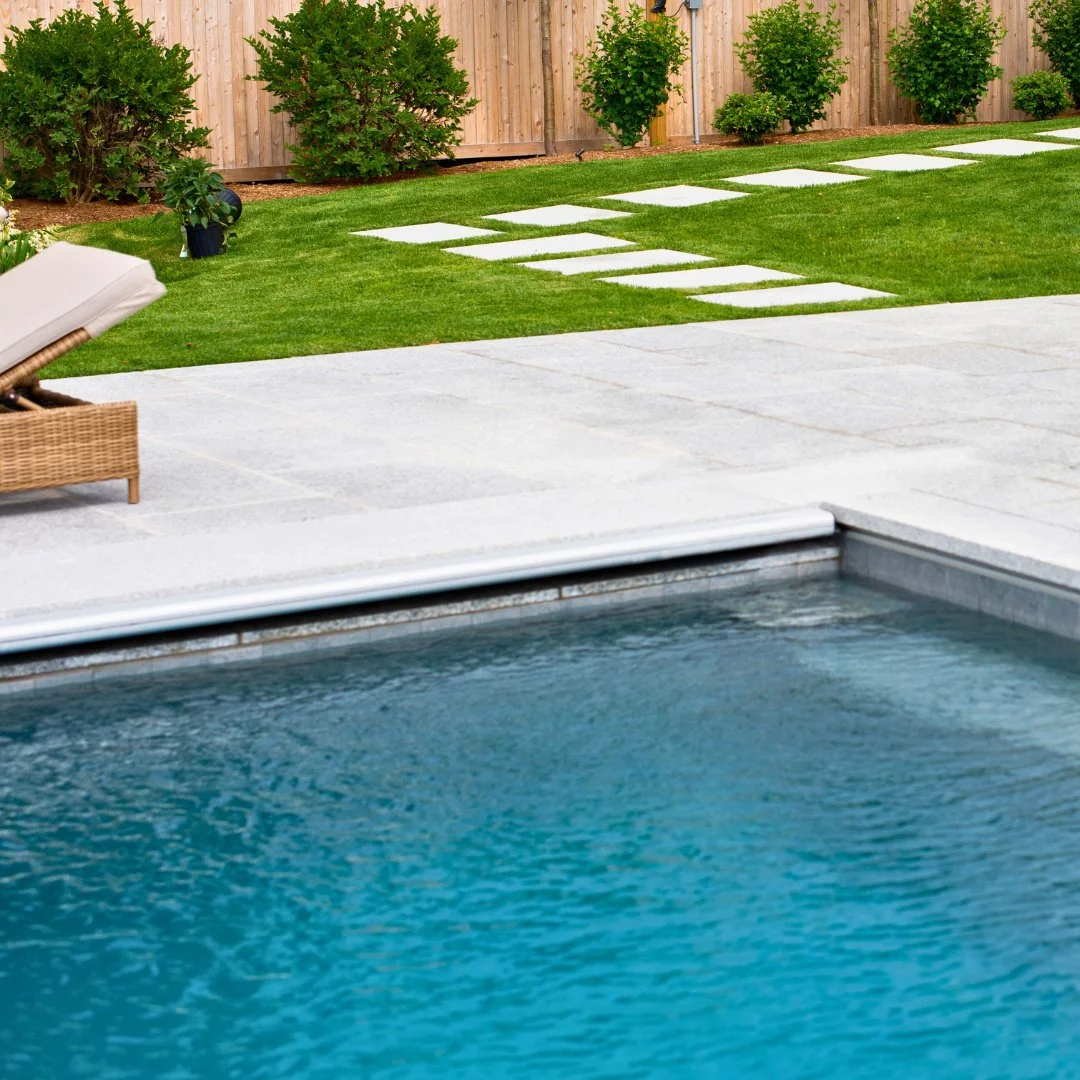 Admiring this pool deck view. Its light tone and thermal finish reflect soft sunlight and help keep the surface cool, perfect for relaxing by the water.