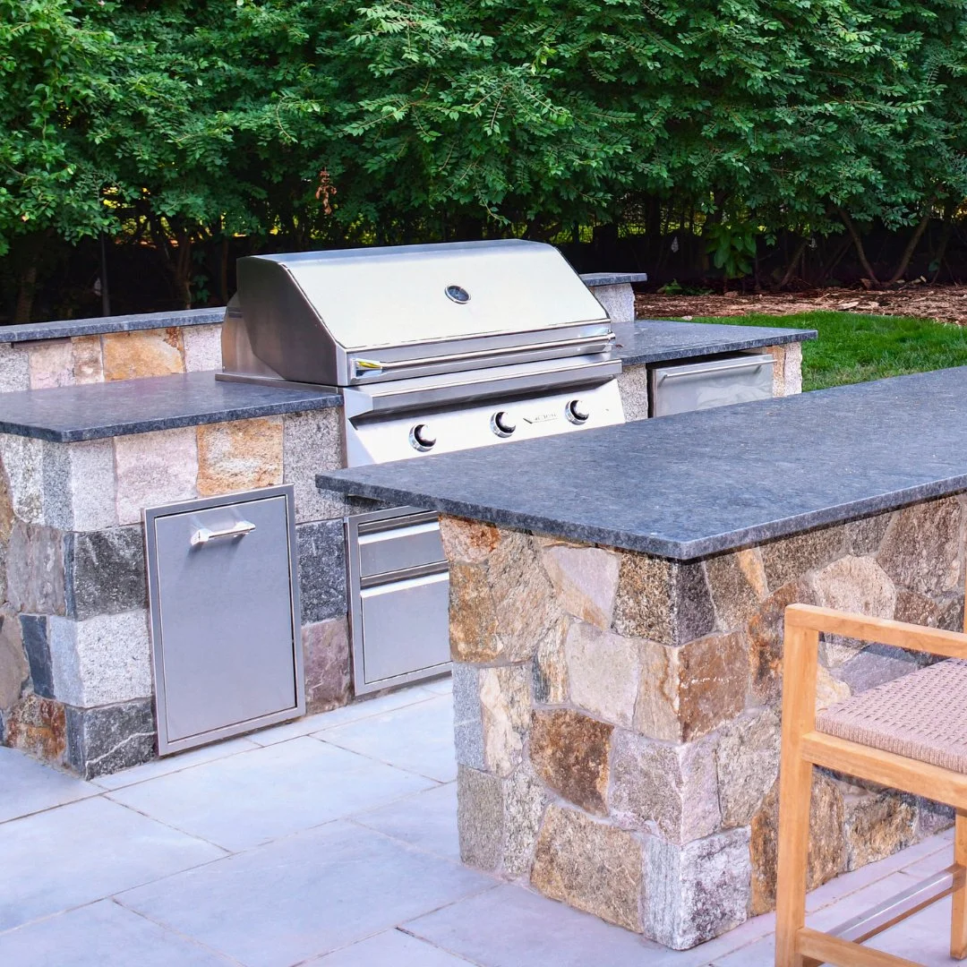 Elevate outdoor living with this custom kitchen featuring a split fieldstone blend and a Bluestone patio. Built to impress and made to last.