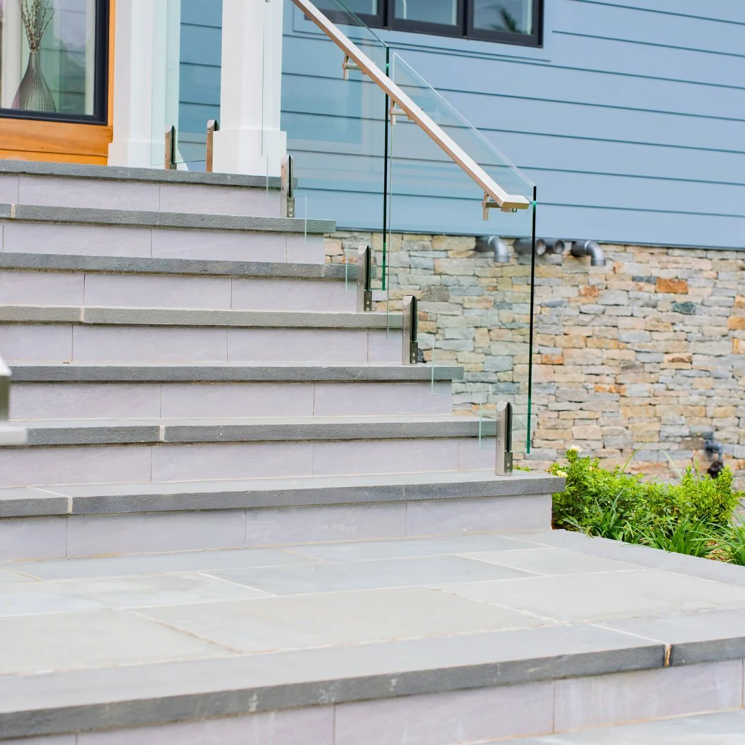 Step up in style. This staircase features elegant Bluestone steps paired with a Gault custom blend veneer at the base of the house, creating a welcoming and timeless entrance.
