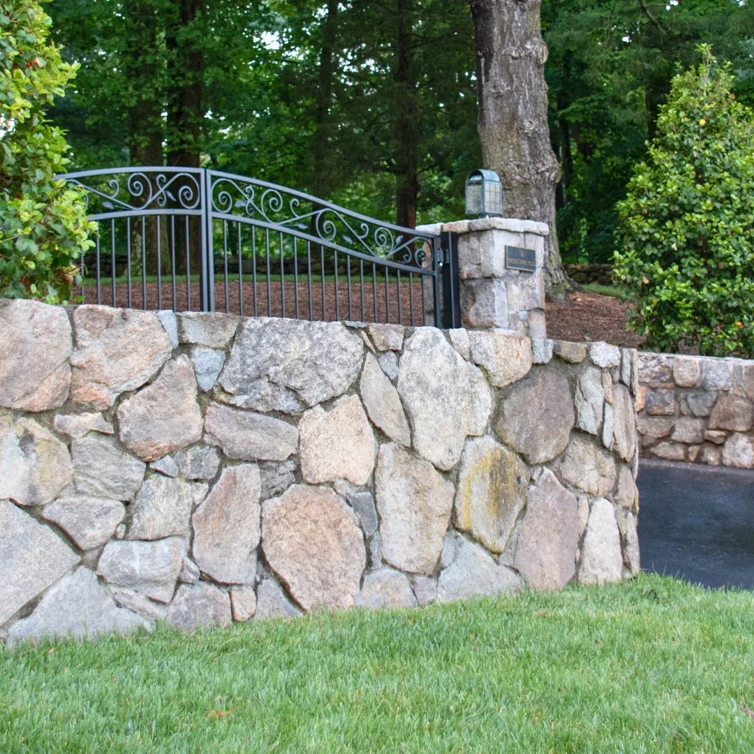 Welcome guests in style. This fieldstone wall frames a gated driveway, adding warmth and character to your home’s entrance as the last leaves of fall settle.