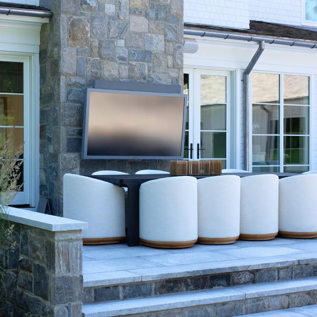 Cozy season, redefined. This Chatham Grey patio brings everyone together for Football Sunday with a Liberty Hill fireplace, mounted TV, and the perfect outdoor setup for crisp fall days.