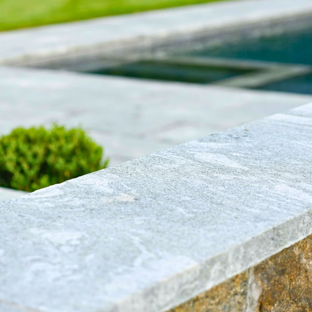 Details that define the space. From the texture of the Imperial Grey stone to the precision of each piece of flagging, craftsmanship is what turns a backyard into a masterpiece.