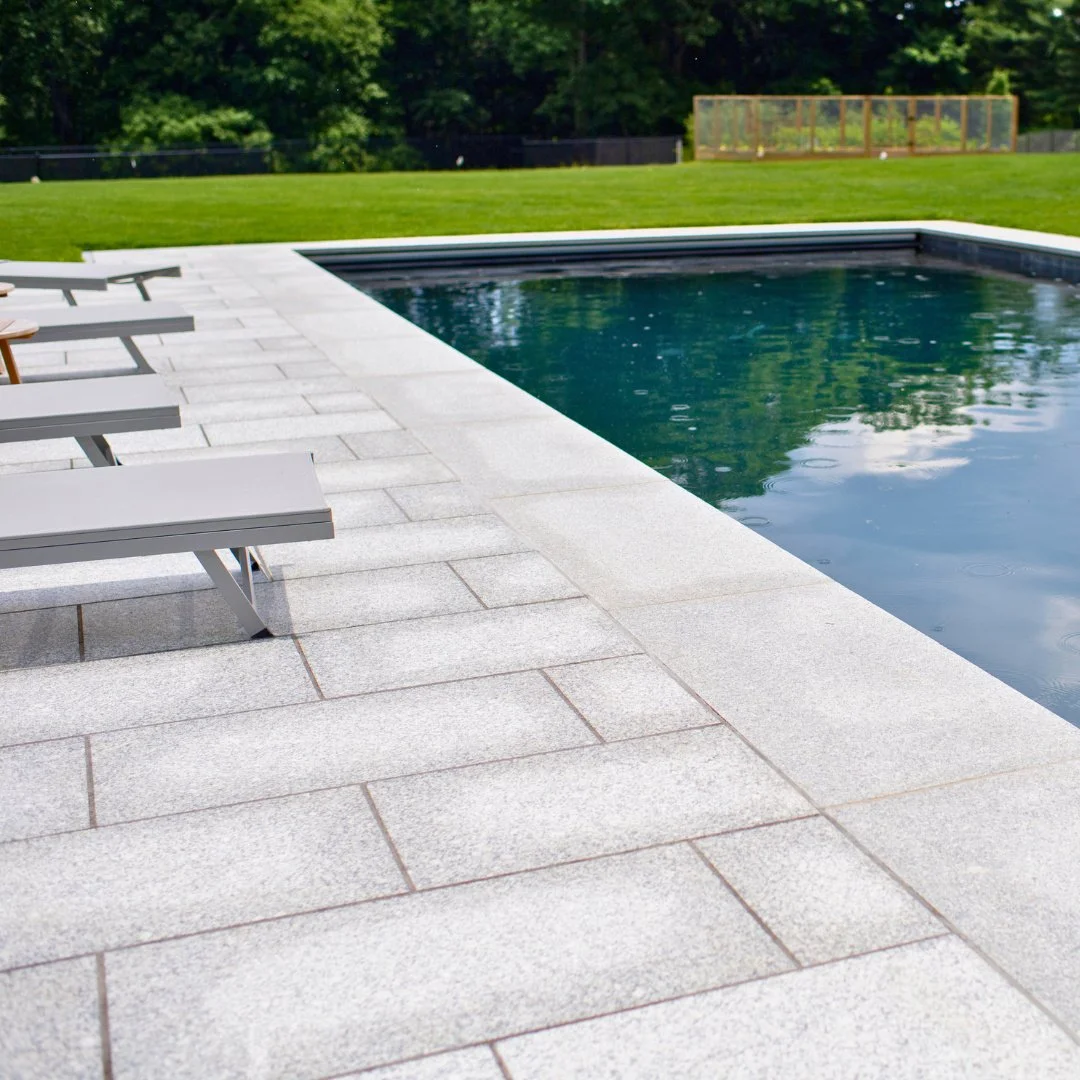 A stone that makes a statement. This backyard retreat combines clean lines and natural tones of Guilford grey granite for a timeless outdoor oasis. Ready for every season!