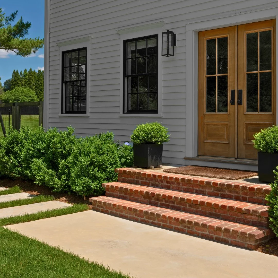 These brick steps add warmth, character, and enduring charm to the front entryway, making the home feel more cozy.