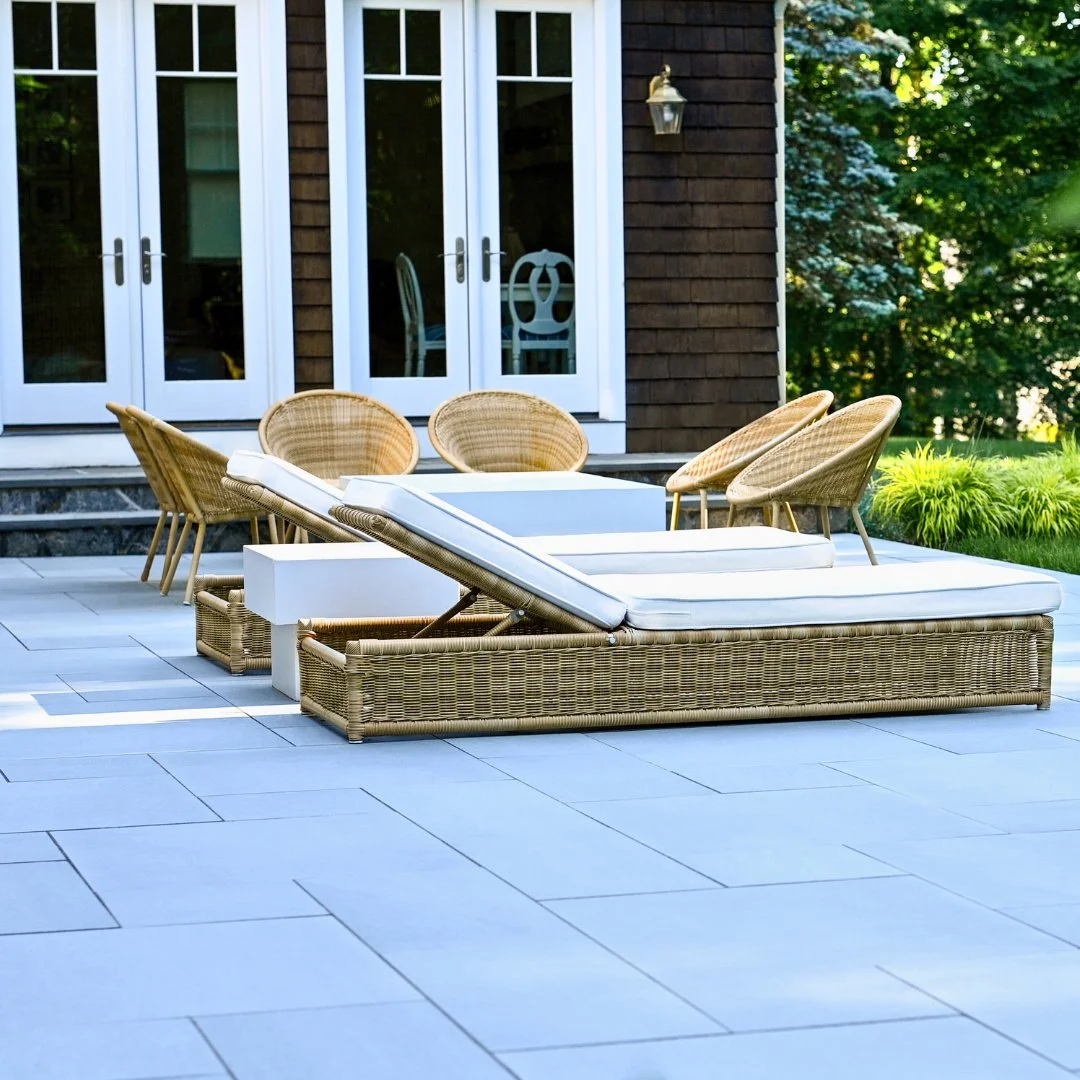 New year, fresh look! This Gault Collection Riverside Blue Porcelain patio with lounging chairs combines comfort and elegance for a perfect winter retreat.