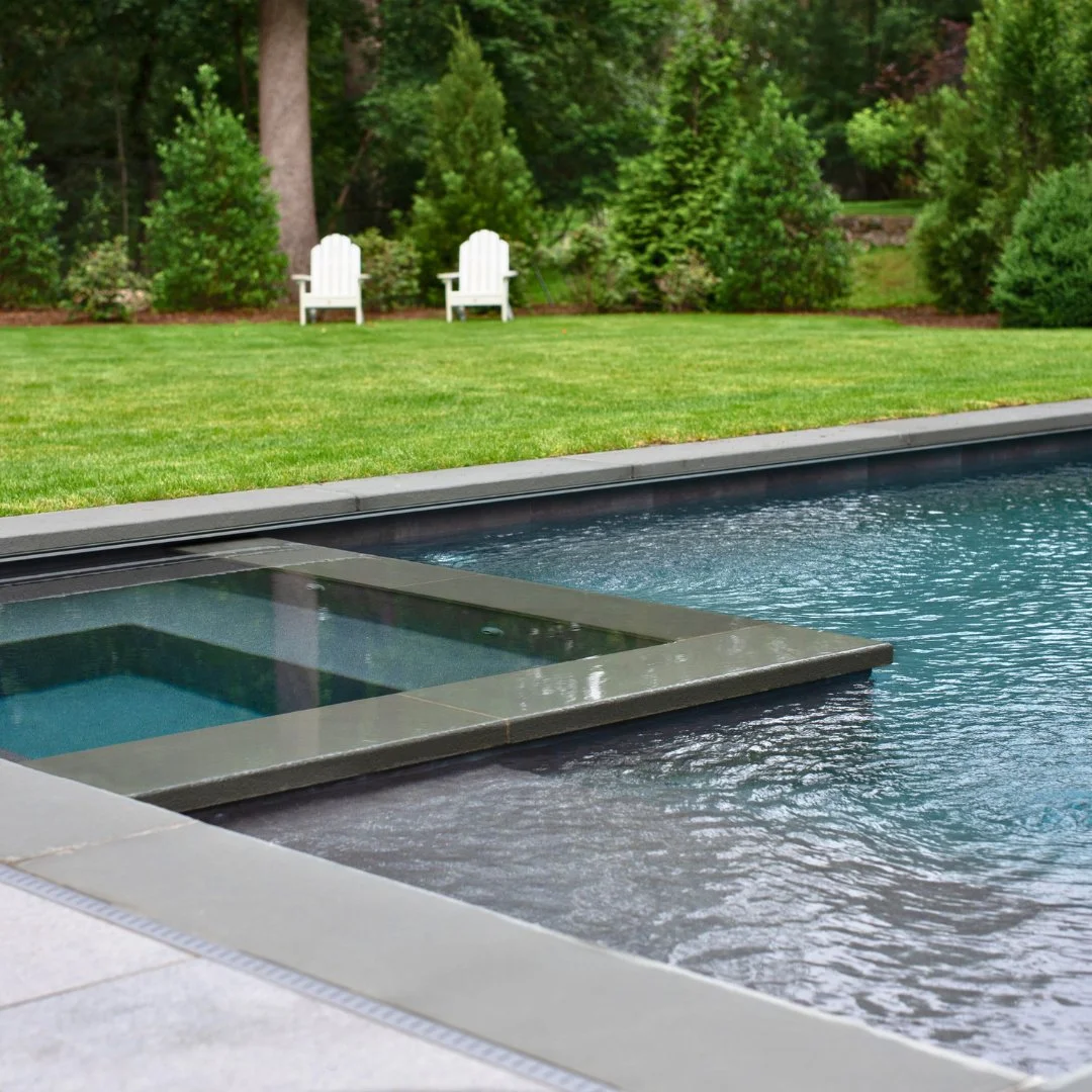 Sleek, modern, and timeless. Thermal Bluestone coping gives this Marsh Grey Porcelain patio a striking winter-ready look.