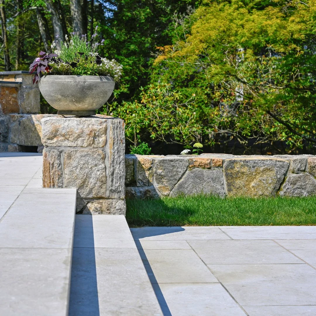 Layered design, endless charm. This two-level Limestone patio adds depth and style to any backyard, even in the crisp January air.