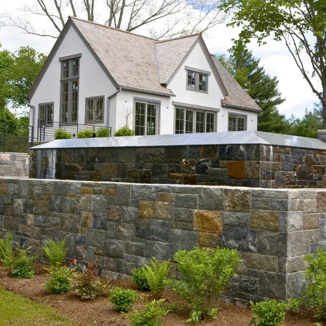 The handcrafted Gault Custom Blend Stone Veneer around this infinity pool brings peace and elegance to any outdoor space.