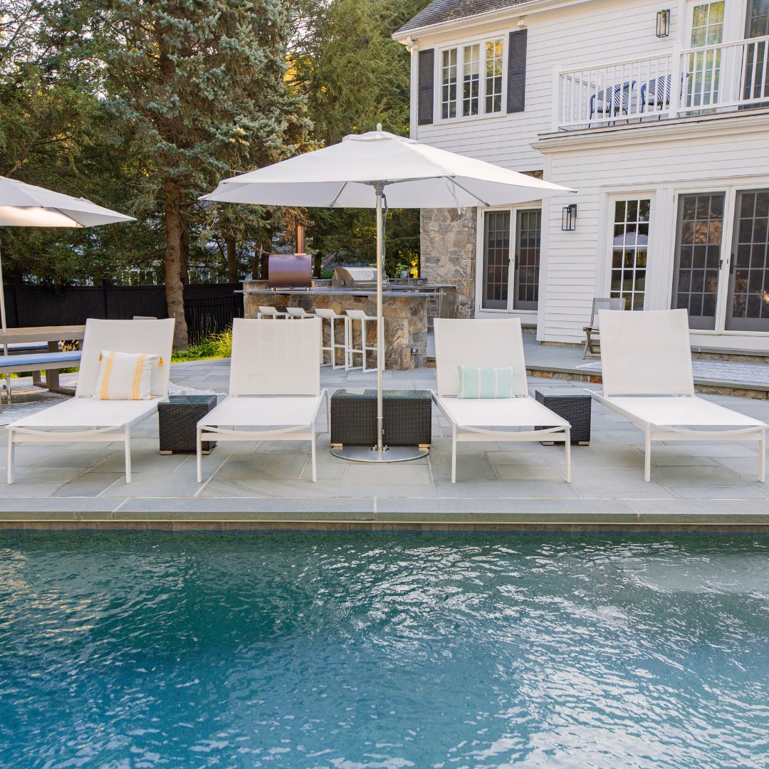 Designed for entertaining from every angle. Bluestone flagging and pool coping create a seamless flow through this backyard retreat, complete with a poolside Fieldstone outdoor kitchen for easy hosting.