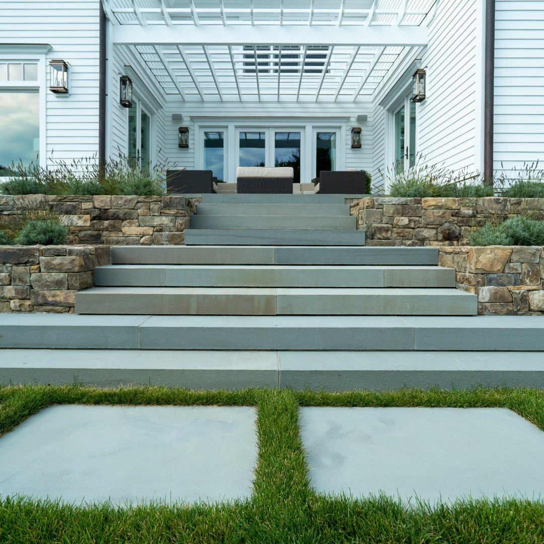 Where every detail matters.
Seen from the ground, the grass joints lead the eye to Bluestone steps that rise to a welcoming seating area - blending natural textures and thoughtful design for a backyard that&rsquo;s ready to celebrate the first day of