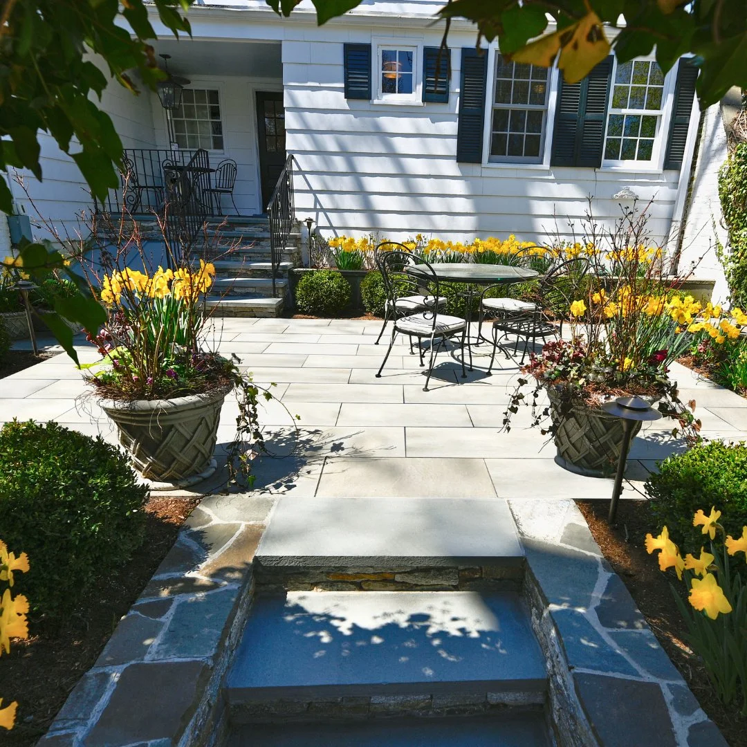 A backyard retreat in full bloom.
This outside Riverside Multi porcelain patio features a cozy seating area surrounded by a vibrant garden of flowers, creating the perfect spot to relax, unwind, and enjoy the beauty of nature right at home.