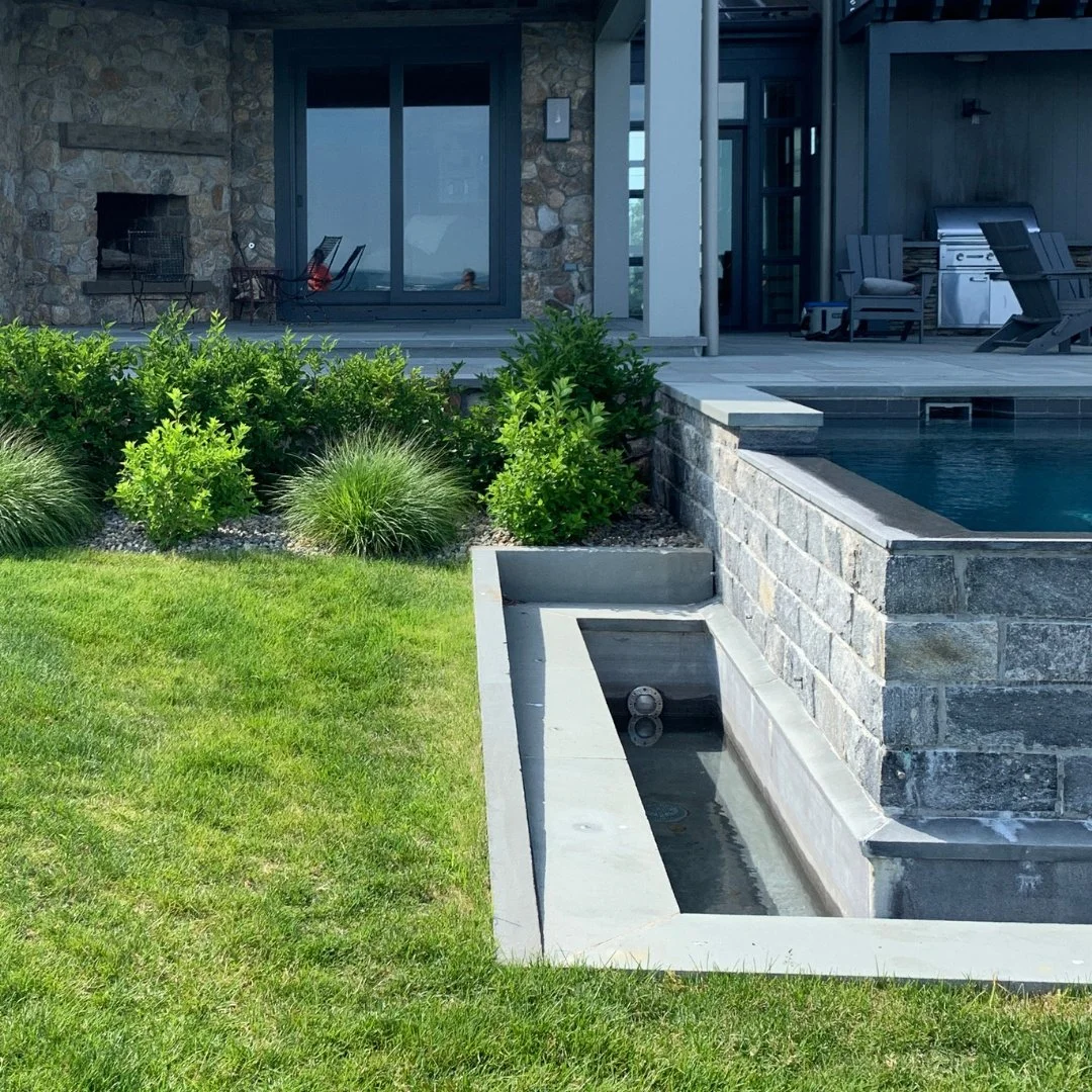 A stunning backyard view built for seamless indoor to outdoor living.
The home foundation features a veneer mix of thinstone weathered rounds, while the infinity pool is framed with Liberty Hill veneer and a bluestone patio - creating a timeless, ele