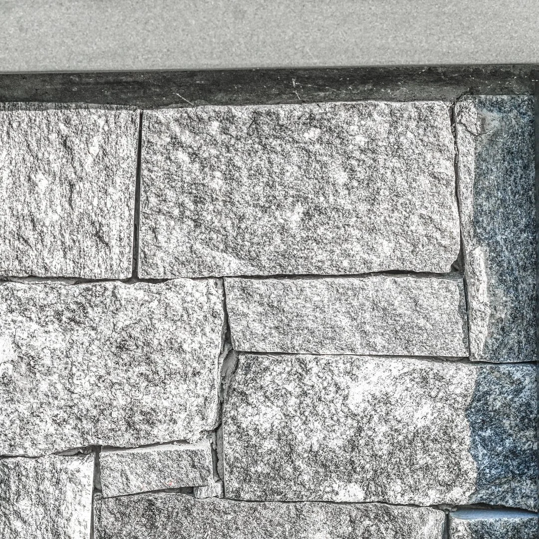The Liberty Hill veneer base and Bluestone countertop of this outdoor grill station add texture and character to the backyard space. Designed as a beautiful and functional area for cooking and entertaining by the pool.