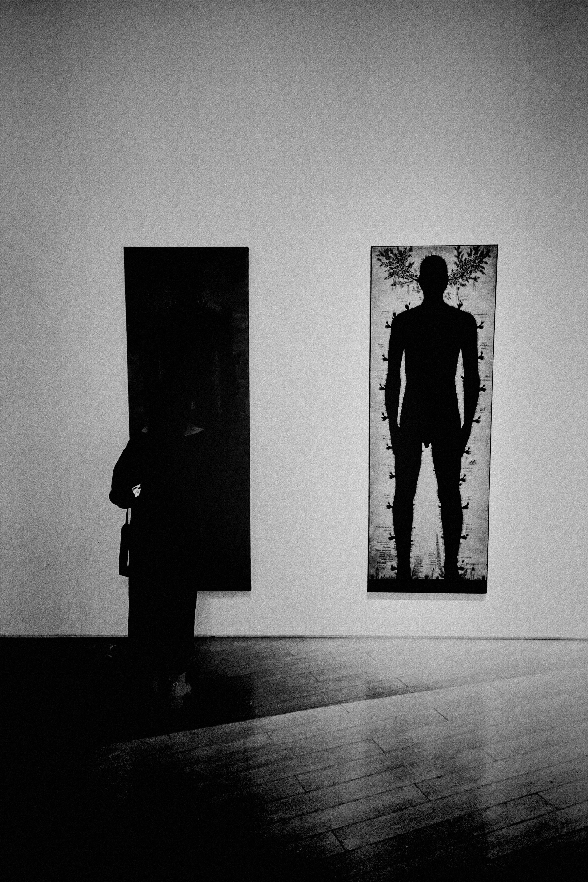 A silhouette of a person standing alone, looking introspective