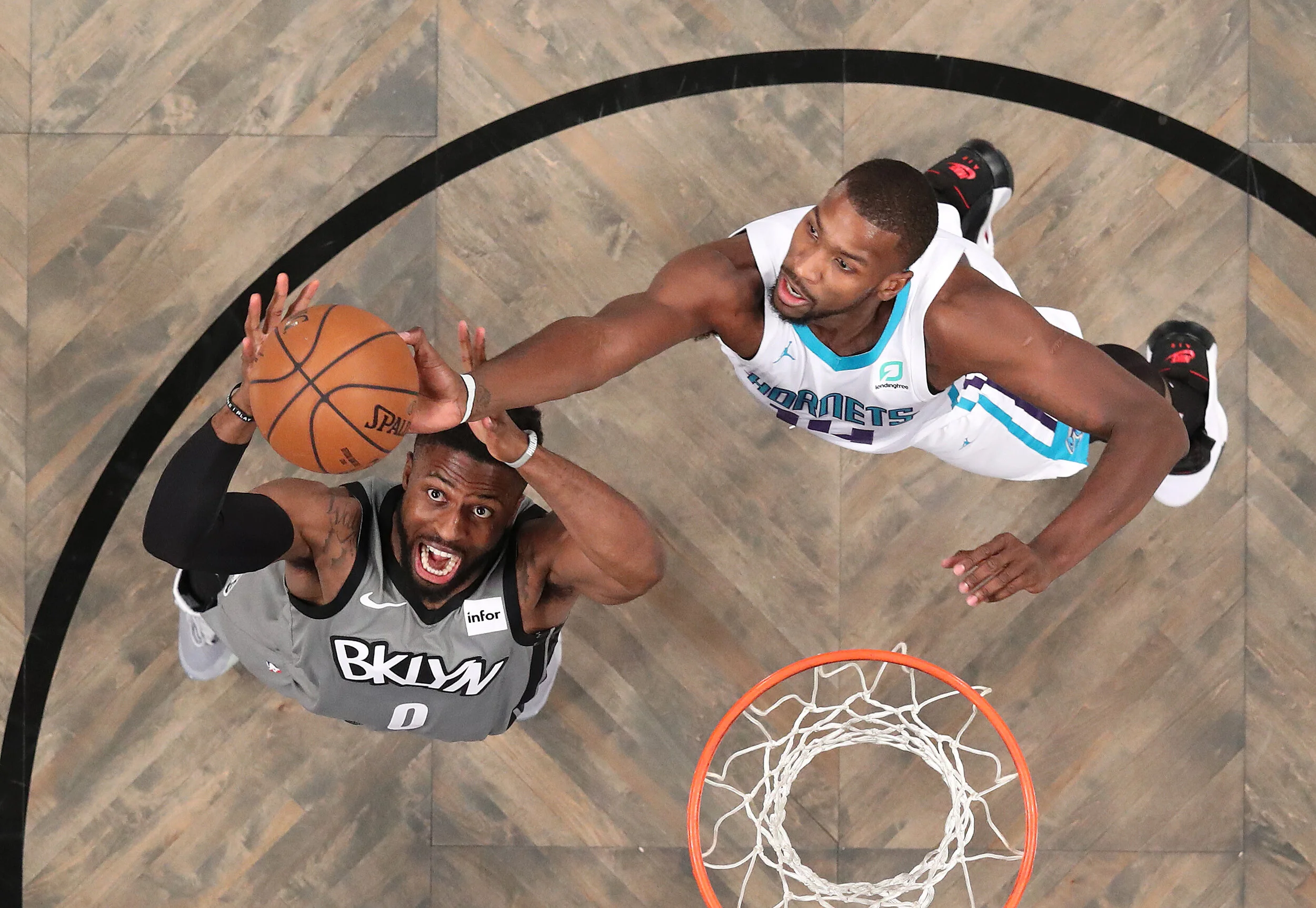  David Nwaba #0 of the Brooklyn Nets and Michael Kidd-Gilchrist #14 of the Charlotte Hornets battle for the ball during the first half at Barclays Center on December 11, 2019 in New York City.  
