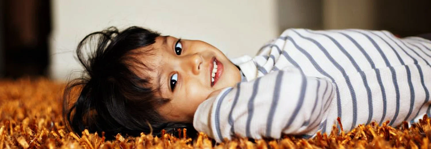 boy_on_orange_carpet.jpg