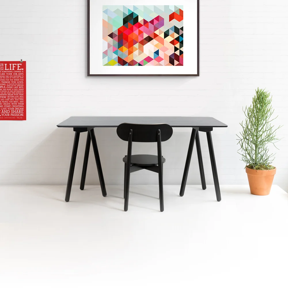 Venture Desk Client: Fab 2014 Rooted in the easy minimalism of classic Scandinavian design, the Venture Desk designed with the lightest of decorative elements. The construction enables assembly with a minimum of hardware. The individual trestles are secured to the top with an oversized plug that adds a graphic element to the tabletop and also creates the optical illusion of the diagonal third leg piercing through the surface. 