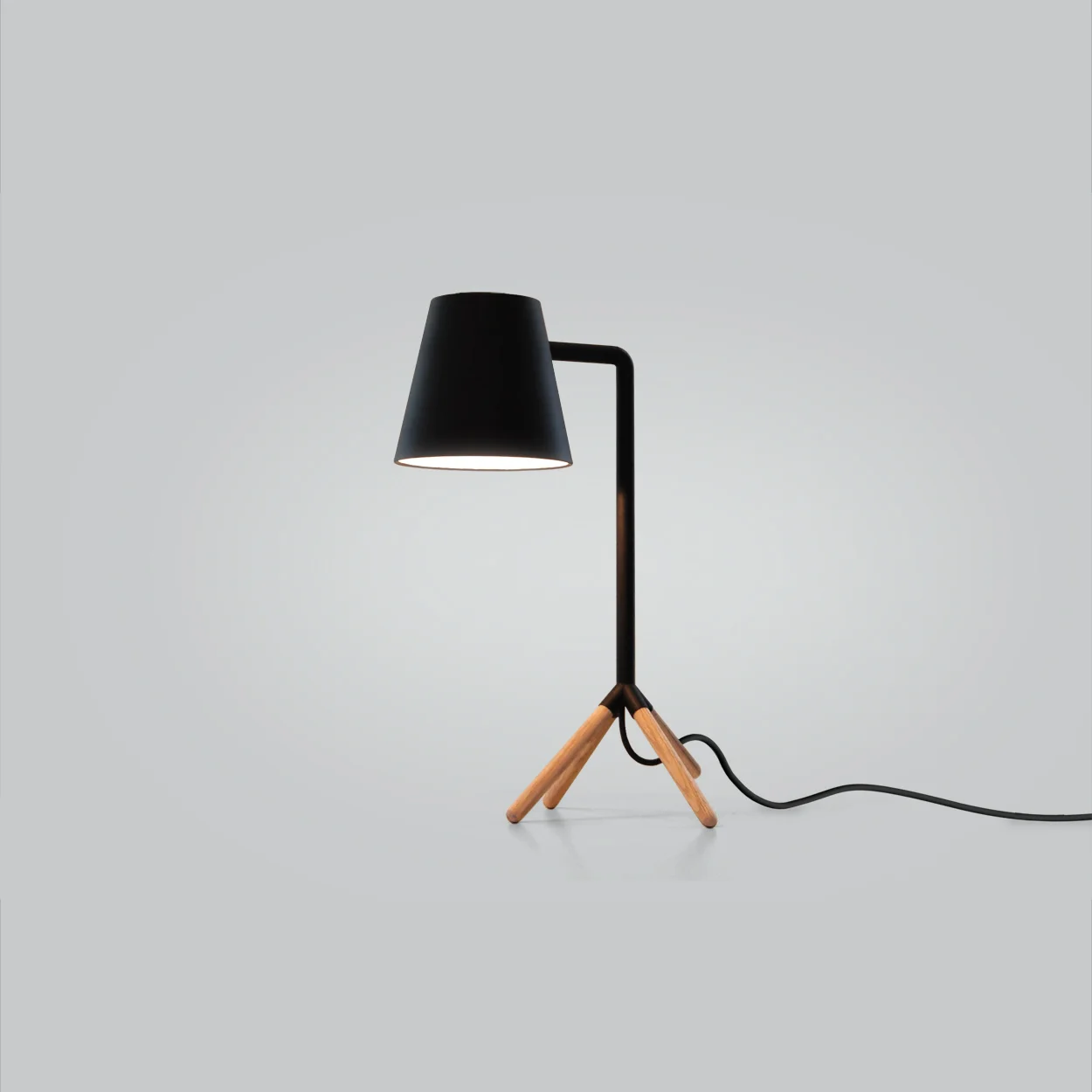 Slightly Awkward Lamp Exhibition: CITE Goes America 2010 The defining beauty in people is often the characteristic that doesn’t fit the standard mold. The Slightly Awkward Desk Lamp is simple and minimal but has a posture that is peculiar, the awkward stance of the lamp with its truncated forth leg gives it life and personality, while allowing it to balance as both an ambient table lamp and a directional task lamp. 