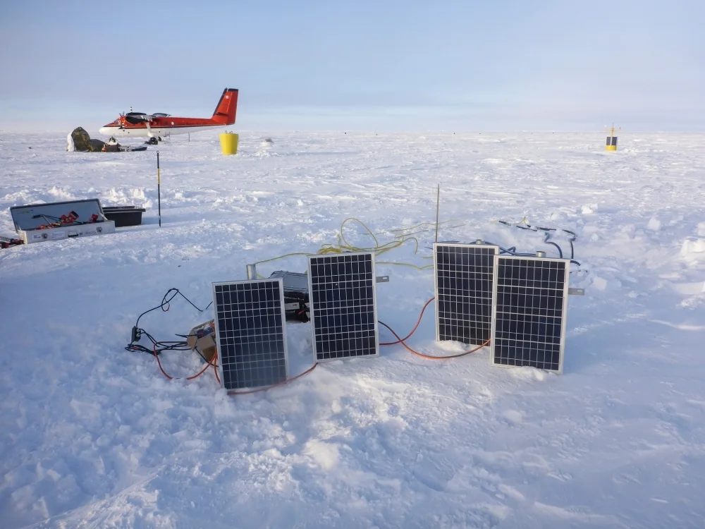 Charging Wave Buoy batteries, with the second Twin Otter (Ken Borek Air) in the background.