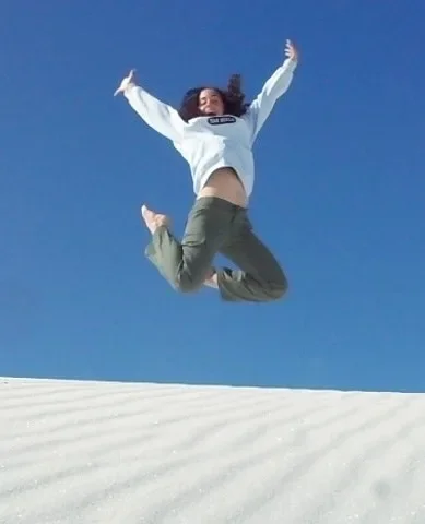 katrina-mcghee-jumping-white-sand-dunes-1200w.webp