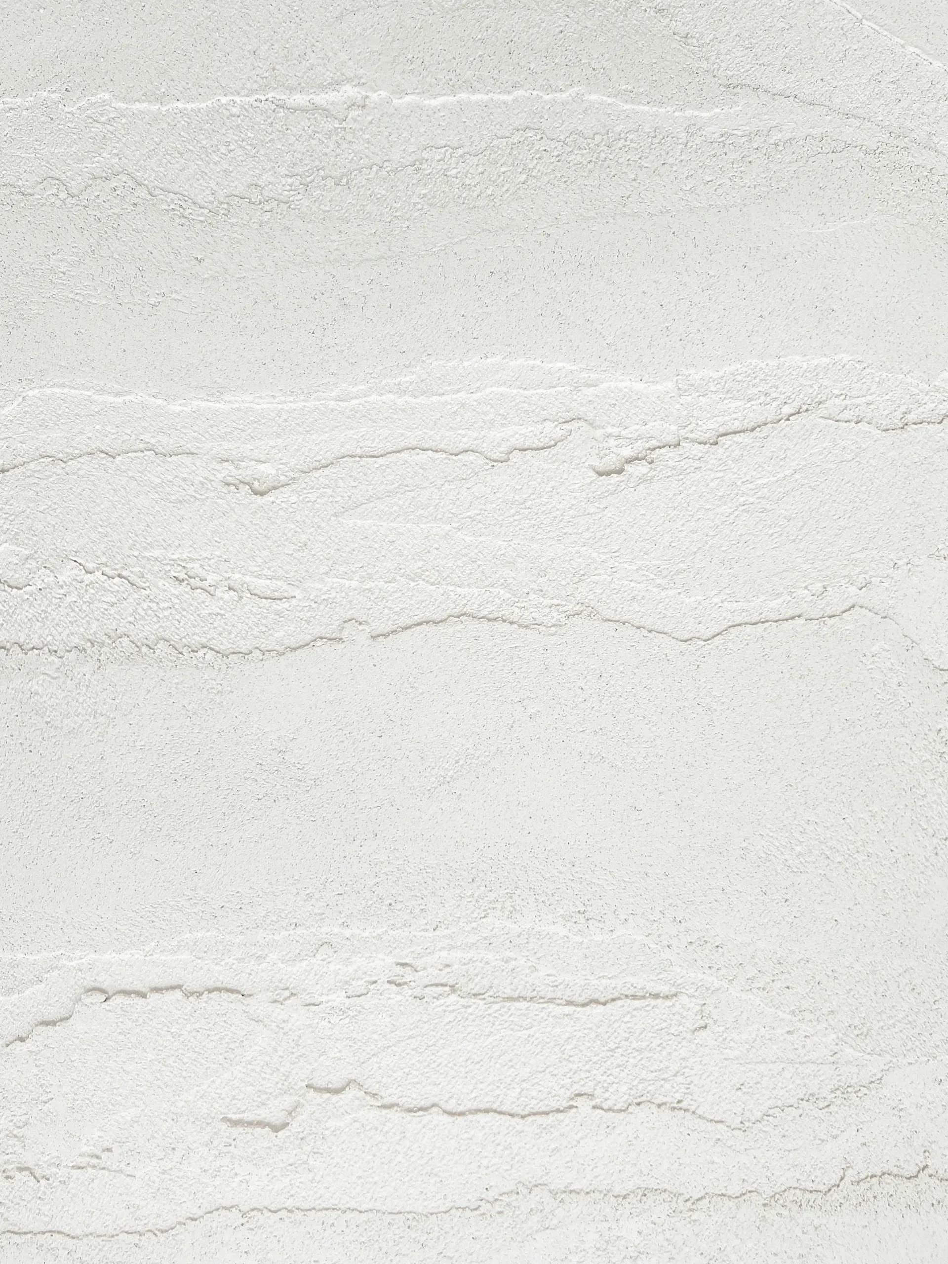 White stucco wall with horizontal layered ridges, clean minimal texture background for career break coaching