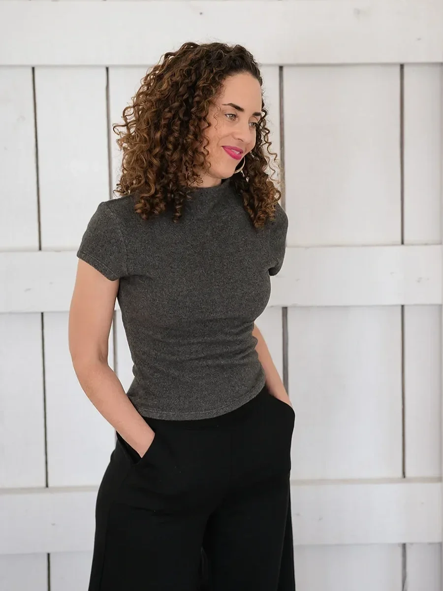 Katrina McGhee sabbatical coach relaxed portrait in grey top with hands in pockets