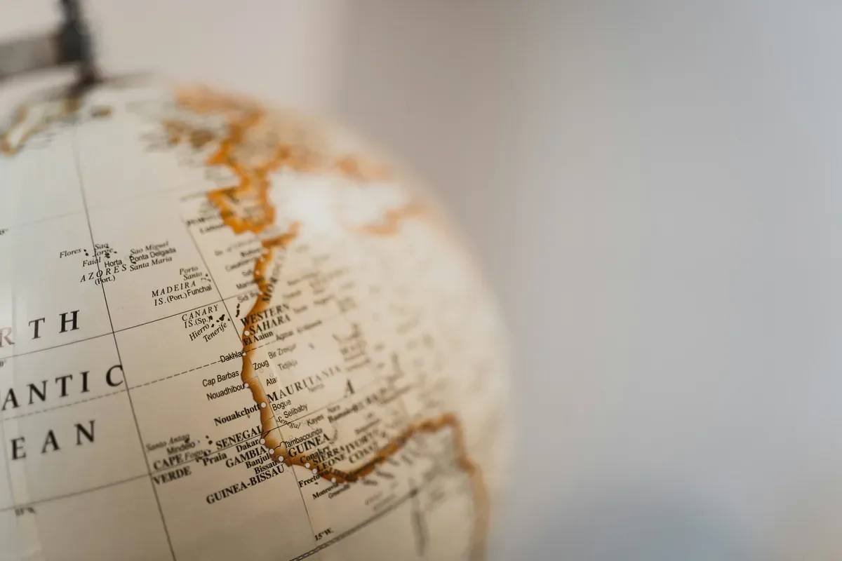 Close-up of a vintage globe showing the Atlantic coast of Africa, evoking world exploration during a career break