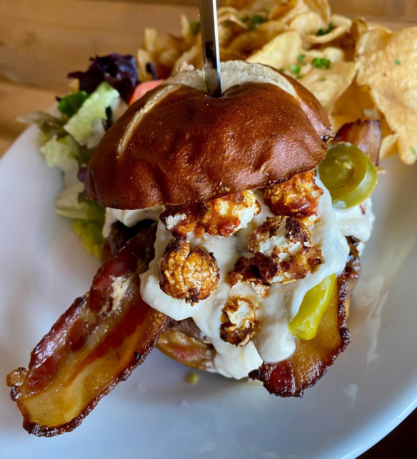Denver on Kipling Burger of the Month - Take Me Out to The Ballpark Burger! Our signature elk-beef blend patty on a toasted pretzel bun with PBR beer cheese, bacon, pickled jalape&ntilde;os &amp; sport peppers, &amp; spiced Cracker Jacks! 
Only avail