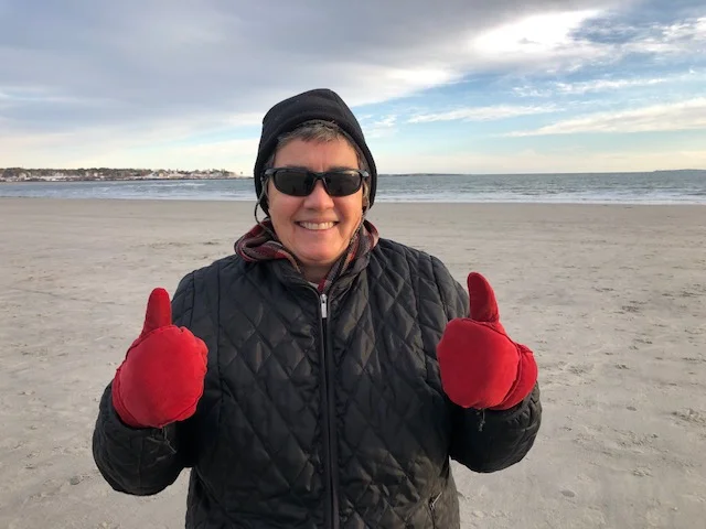 Brenda thumbs up on a cold beach.jpg