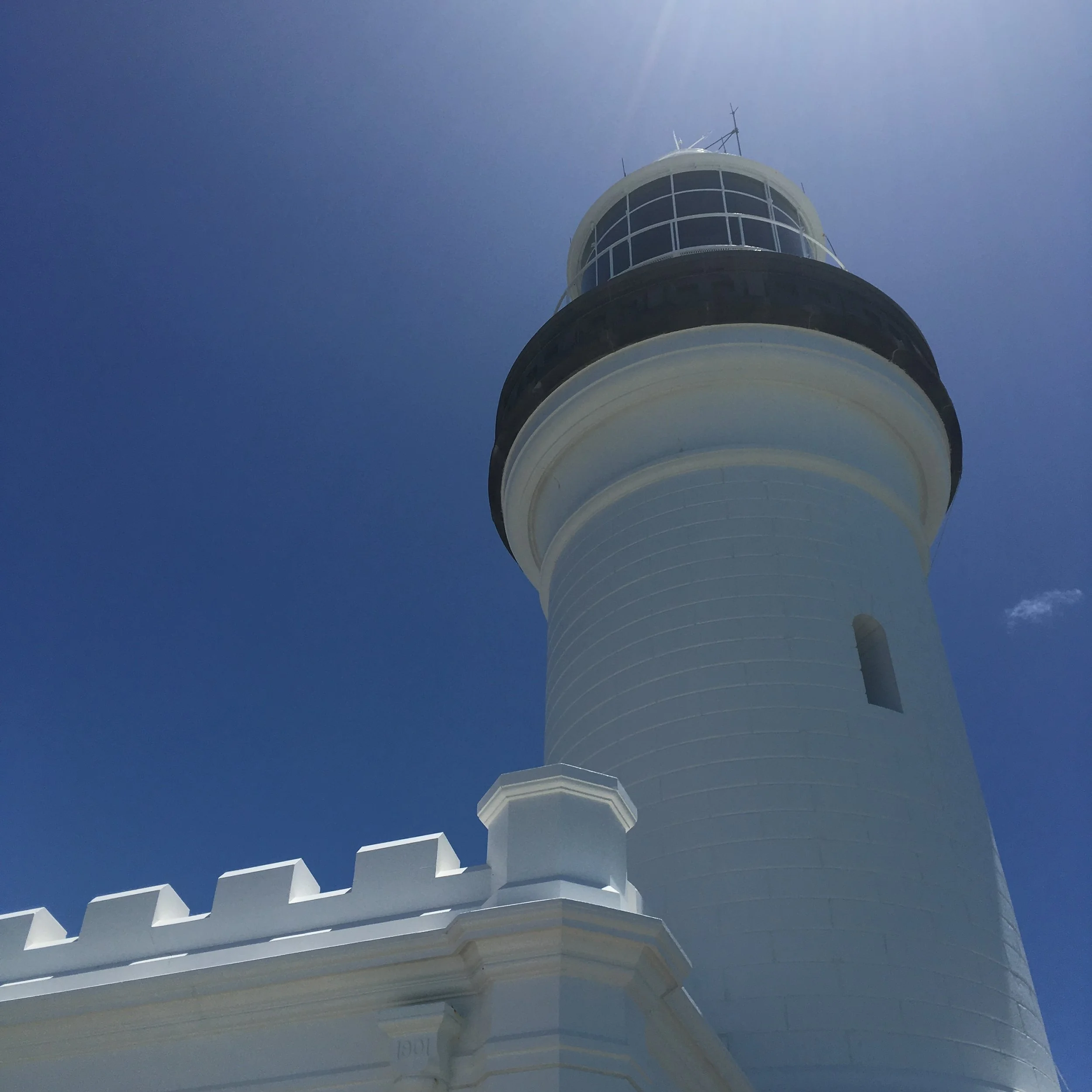 White lighthouse against a clear blue sky