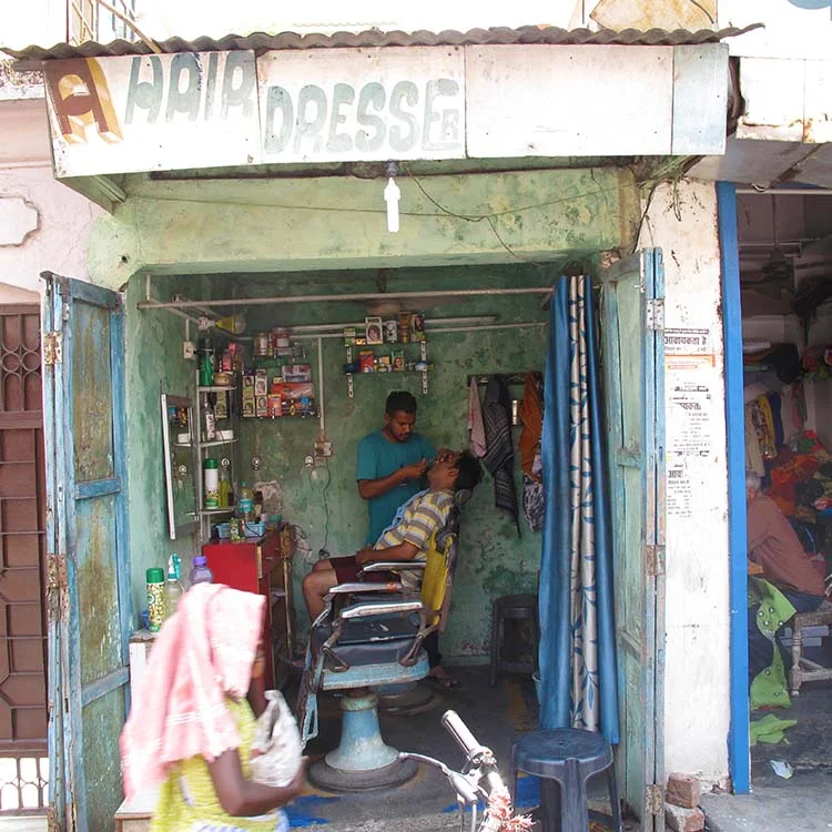 A small barbershop with a man getting a shave