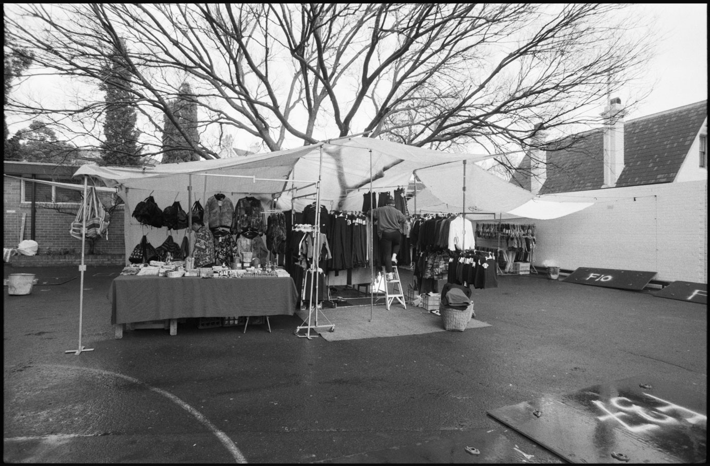 Nick Carroll sets up his active wear stall on a wet autumn morning | 1992 | R27A-03