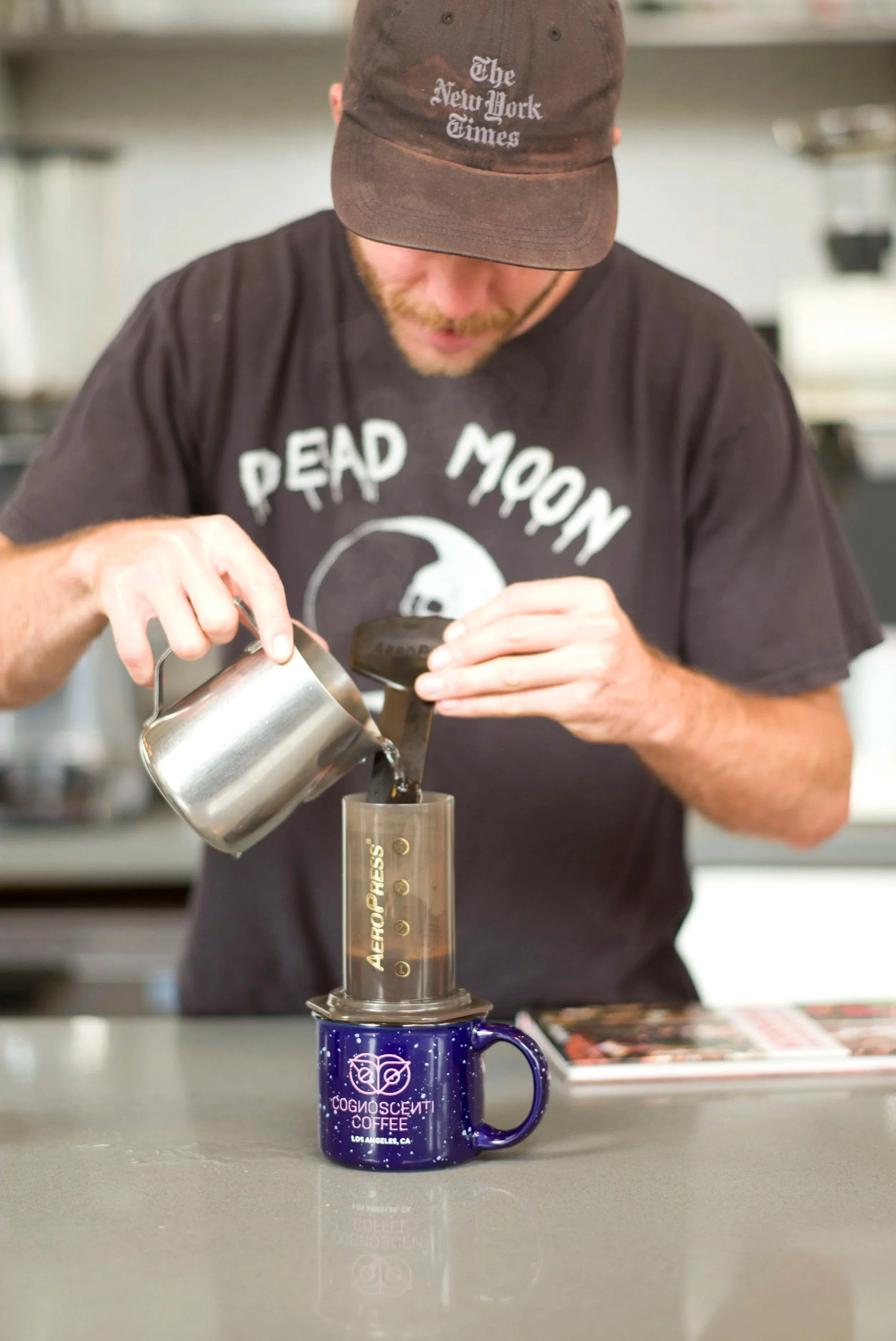 barista making coffee with an aeropress