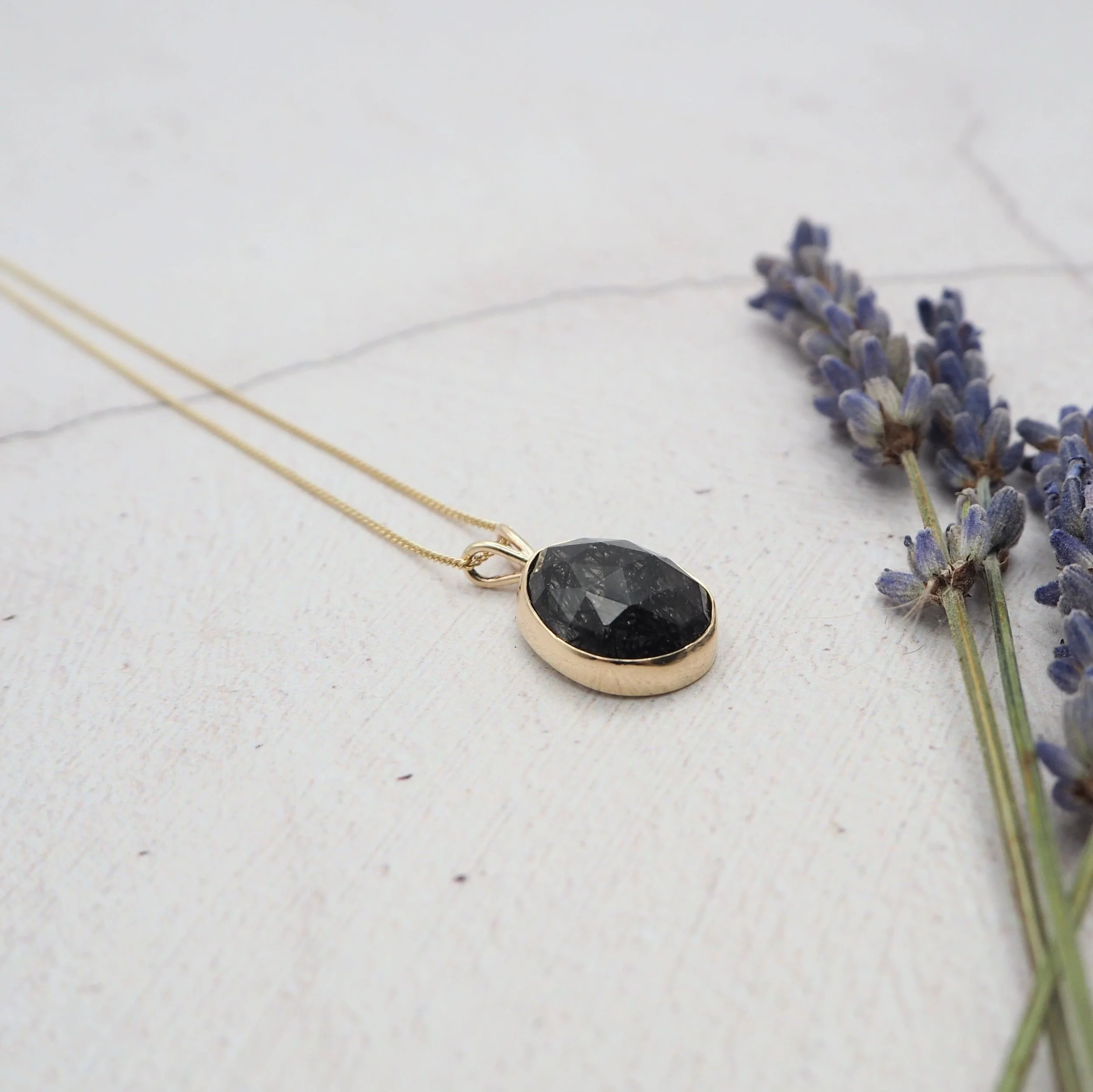 Recycled gold and black tourmalinated quartz pendant.