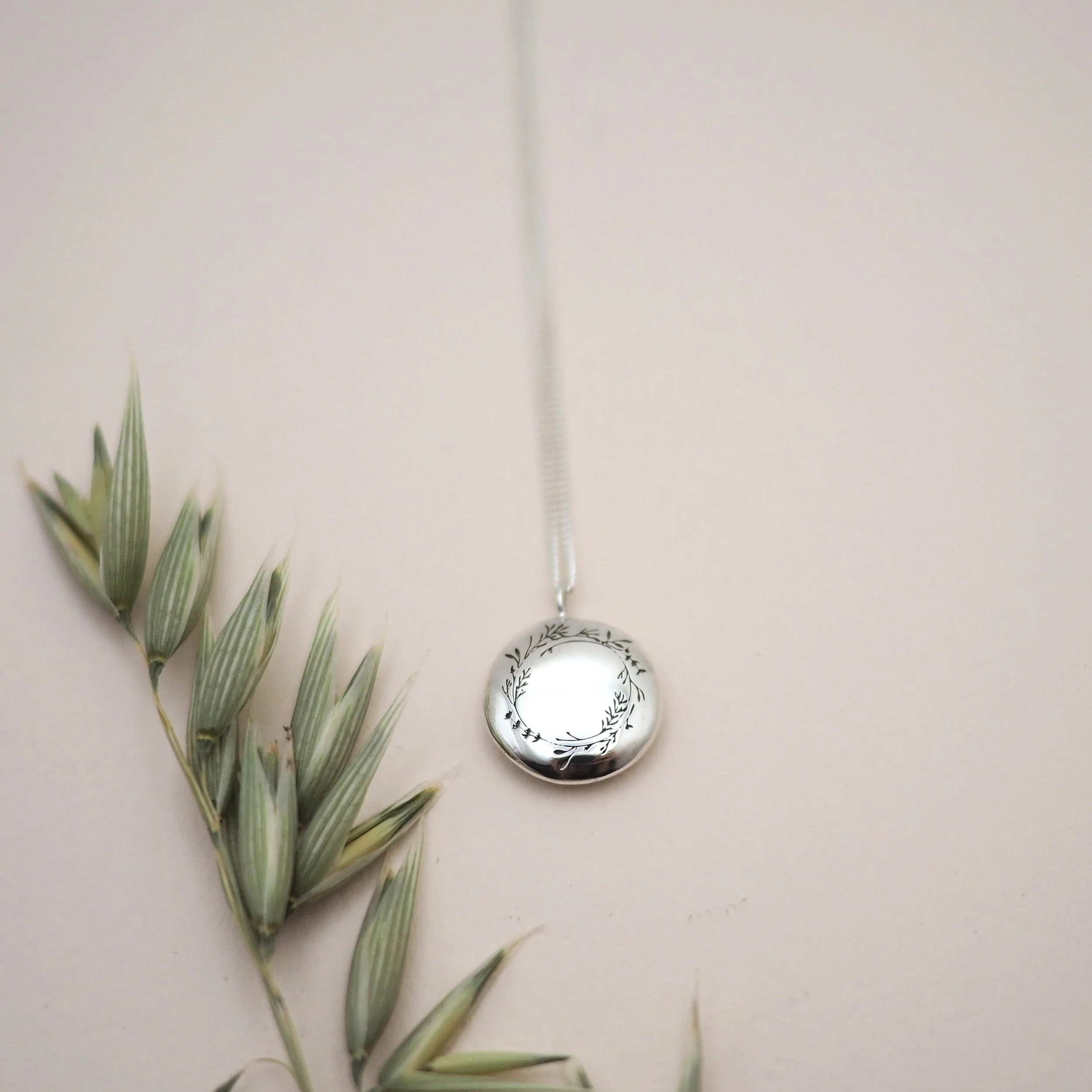 Floral wreath pendant in recycled silver