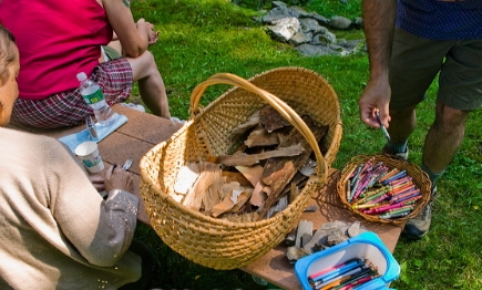 writing prayers on birch bark at 'Sounding the River' to float on the Hudson River photo:Keith Emerling
