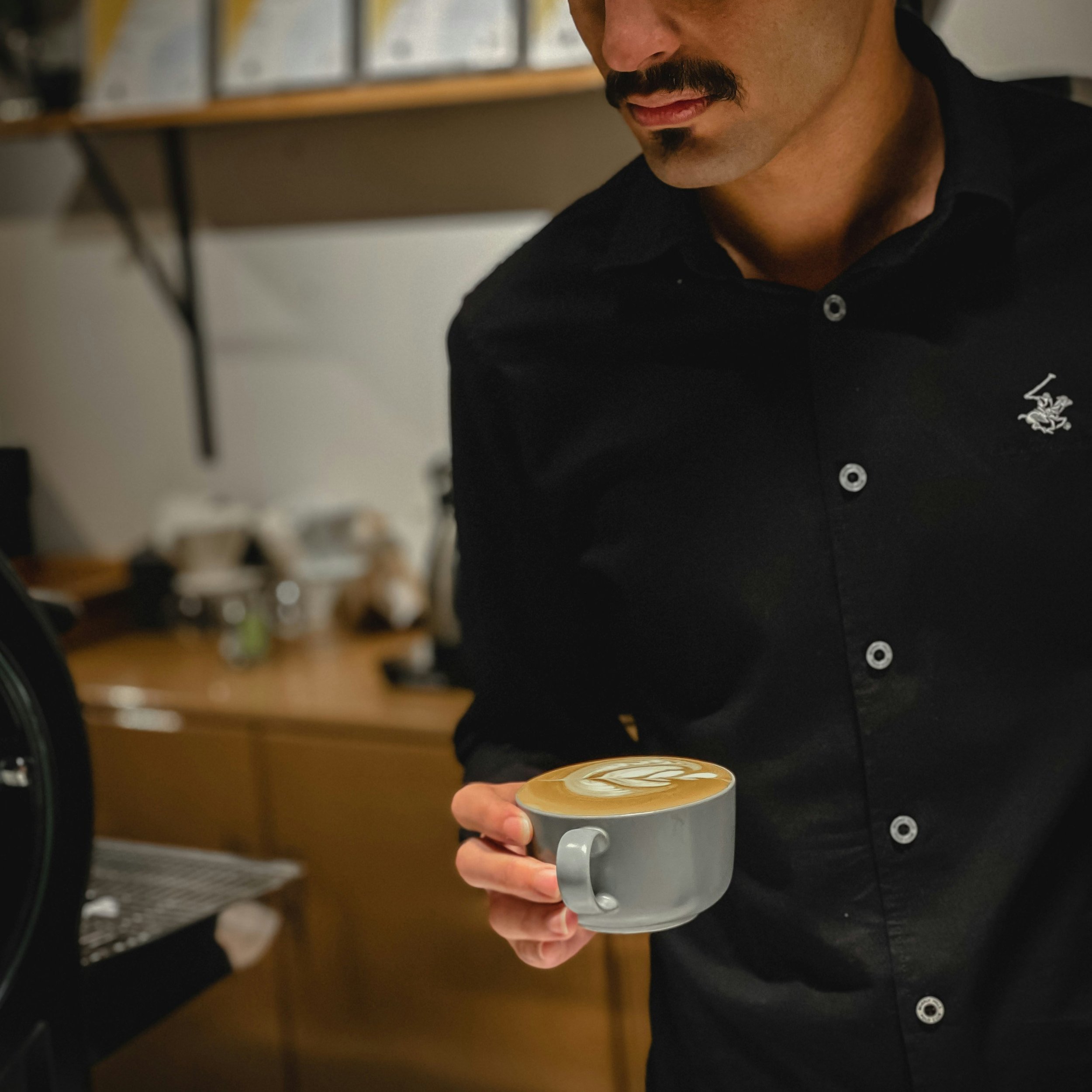 Barista handing over double espresso