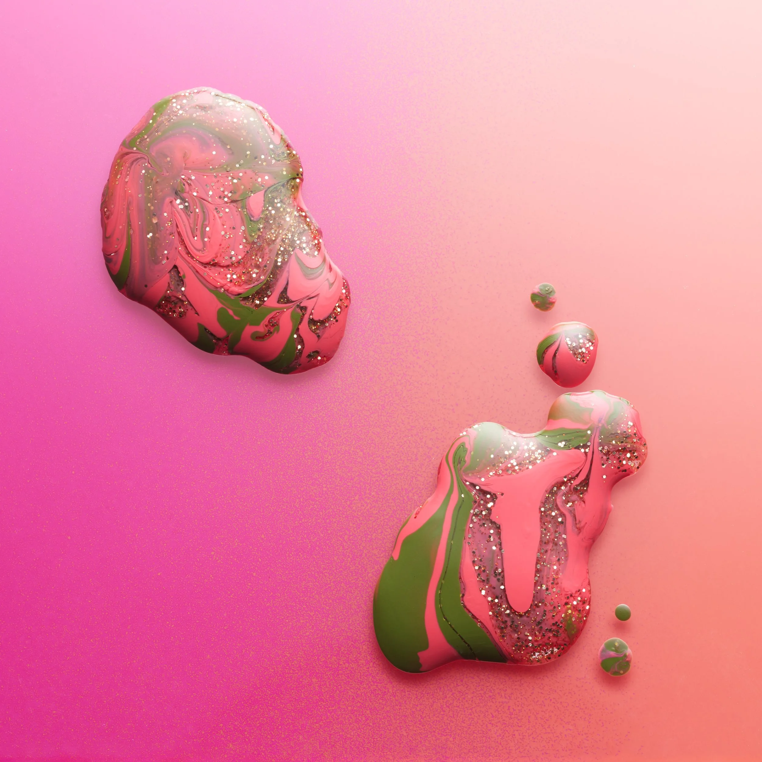 Abstract marble-like object with pink, green, and gold colors, on a pink background.