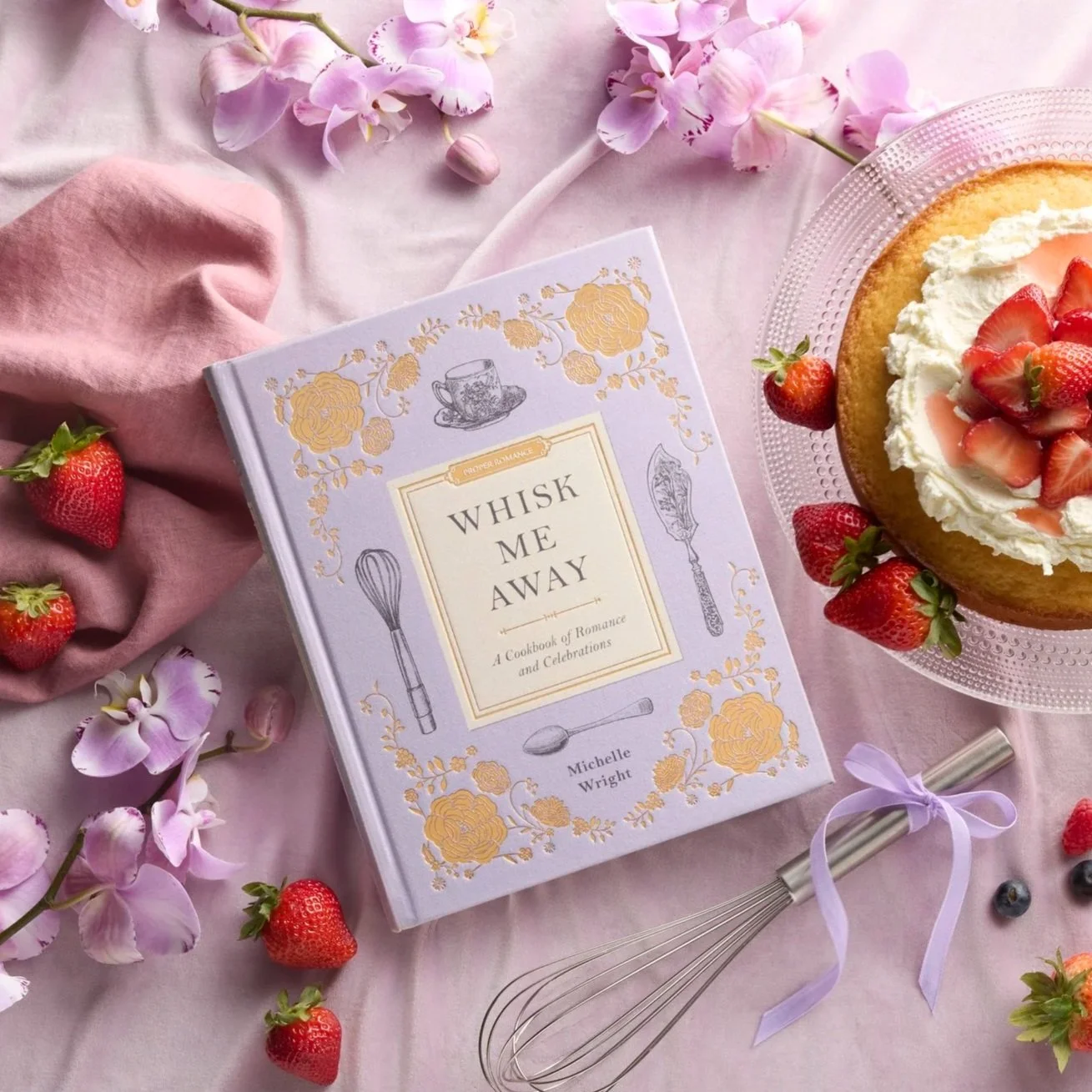 Professional food and prop styling for the 'Whisk Me Away' cookbook advertisement. The image features the cookbook surrounded by curated, historical-themed props and dishes, highlighting the Proper Romance brand aesthetic