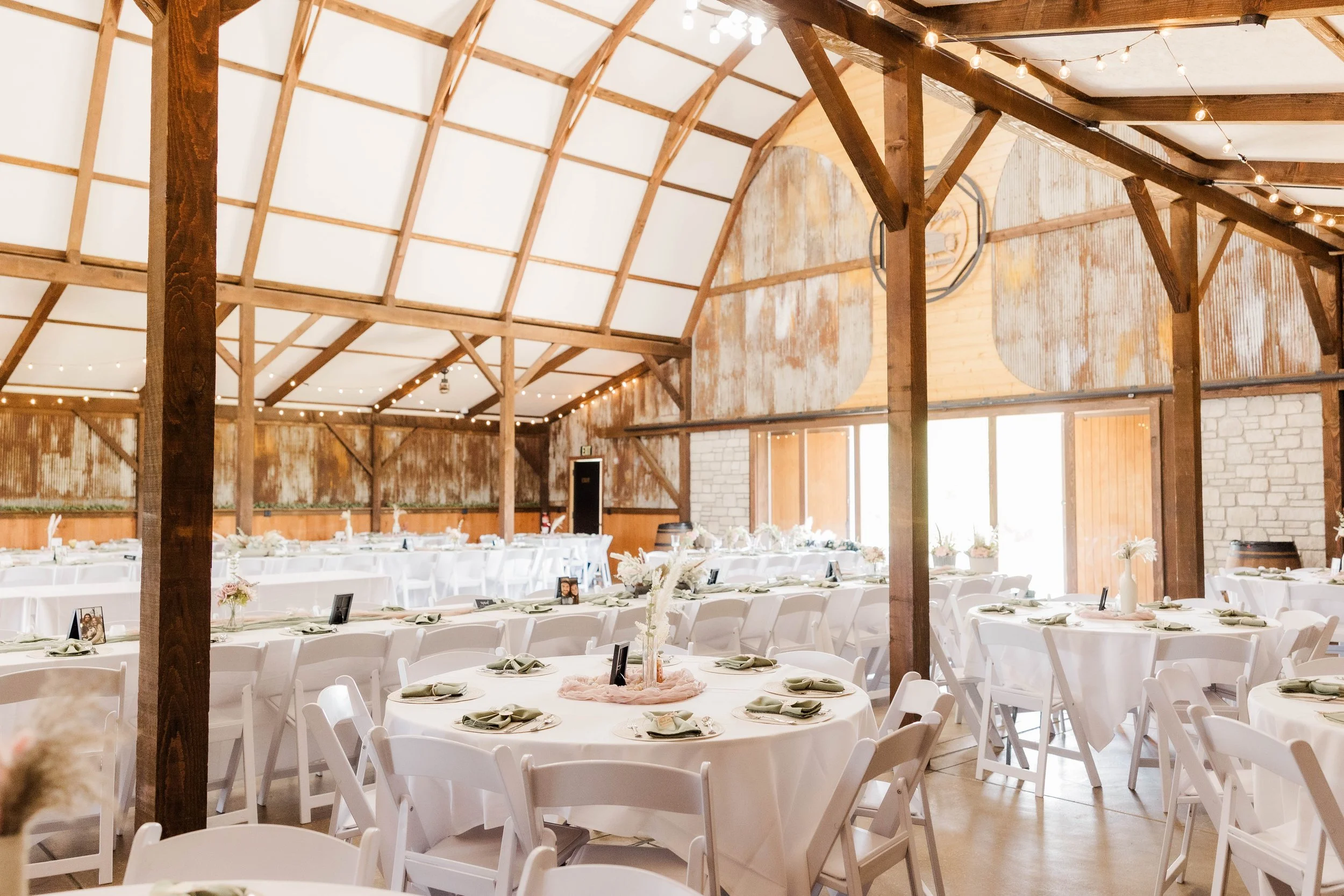 Rustic barn wedding venue at The Barn at Lone Eagle Landing with outdoor and indoor ceremony setup.