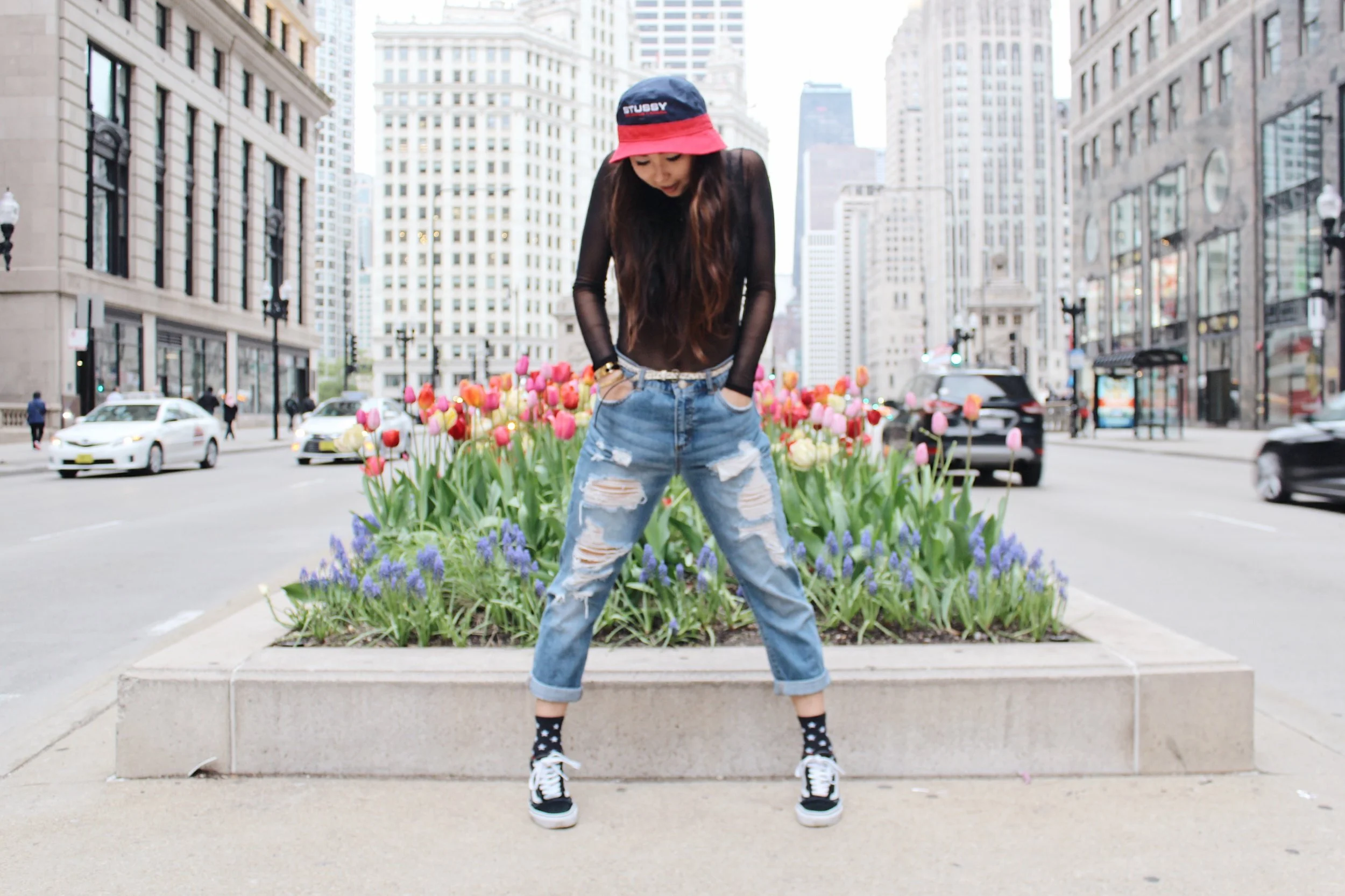 Ginger wears bucket hat, Stüssy ; boyfriend jeans, Tommy Hilfiger ; socks, Stance ; sneakers, Vans .