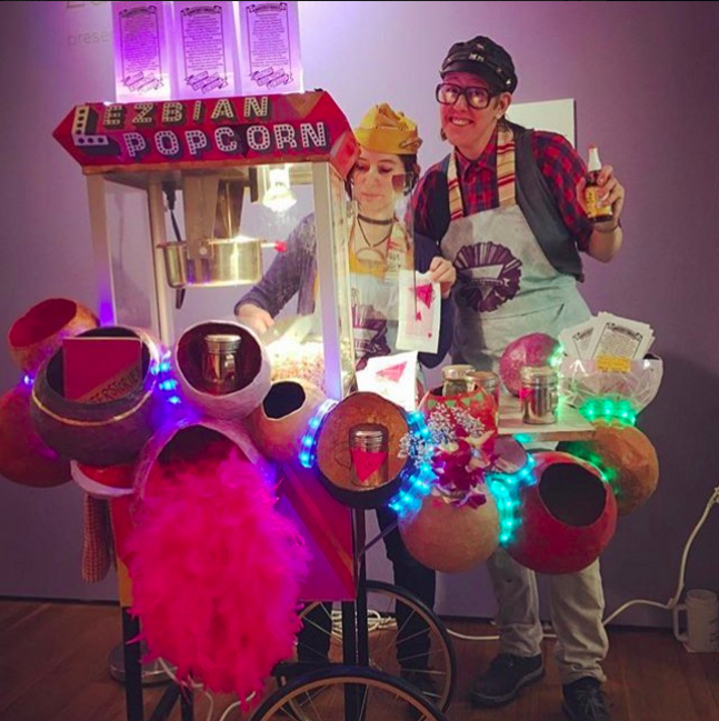 Artist Rachael Shannon and Queerstories: Lezbian Popcorn Cart offers dyke history printed on popcorn bags at the bar