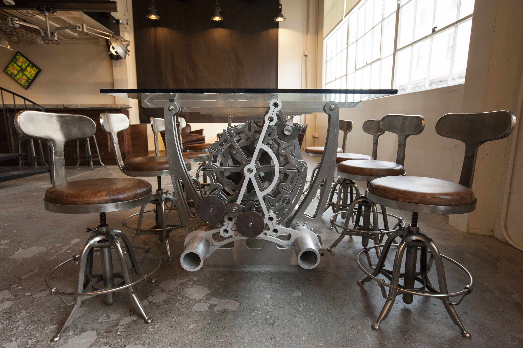  Originally the blacksmith and machine shop for Fort Mason, our design brings a modern spirit to the 1930's era history of the space. Vintage stools and historic concrete floors speak to the original machine-shop space of the space. While a palette o