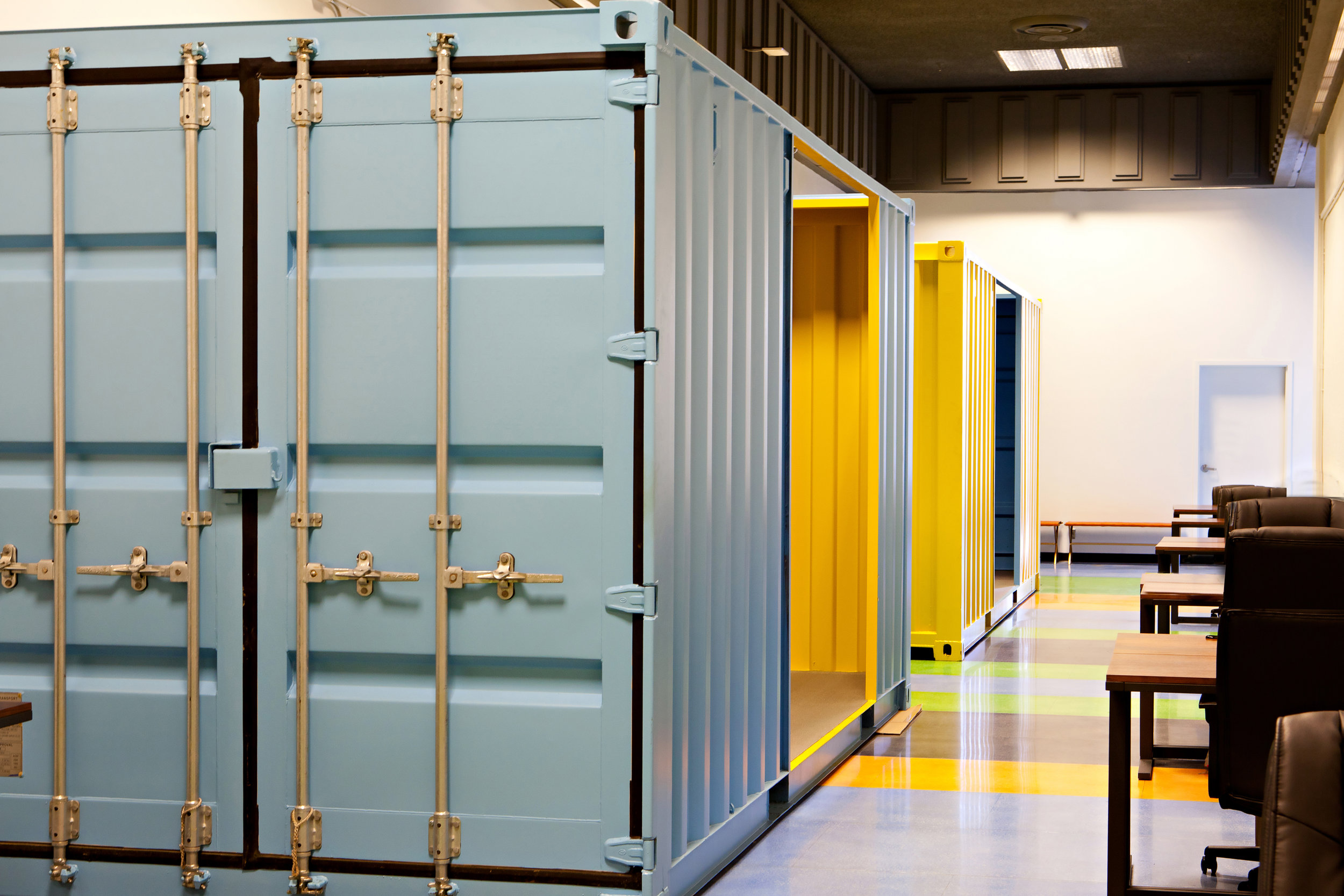  Vibrant shipping container-meeting rooms line the large hallways. 