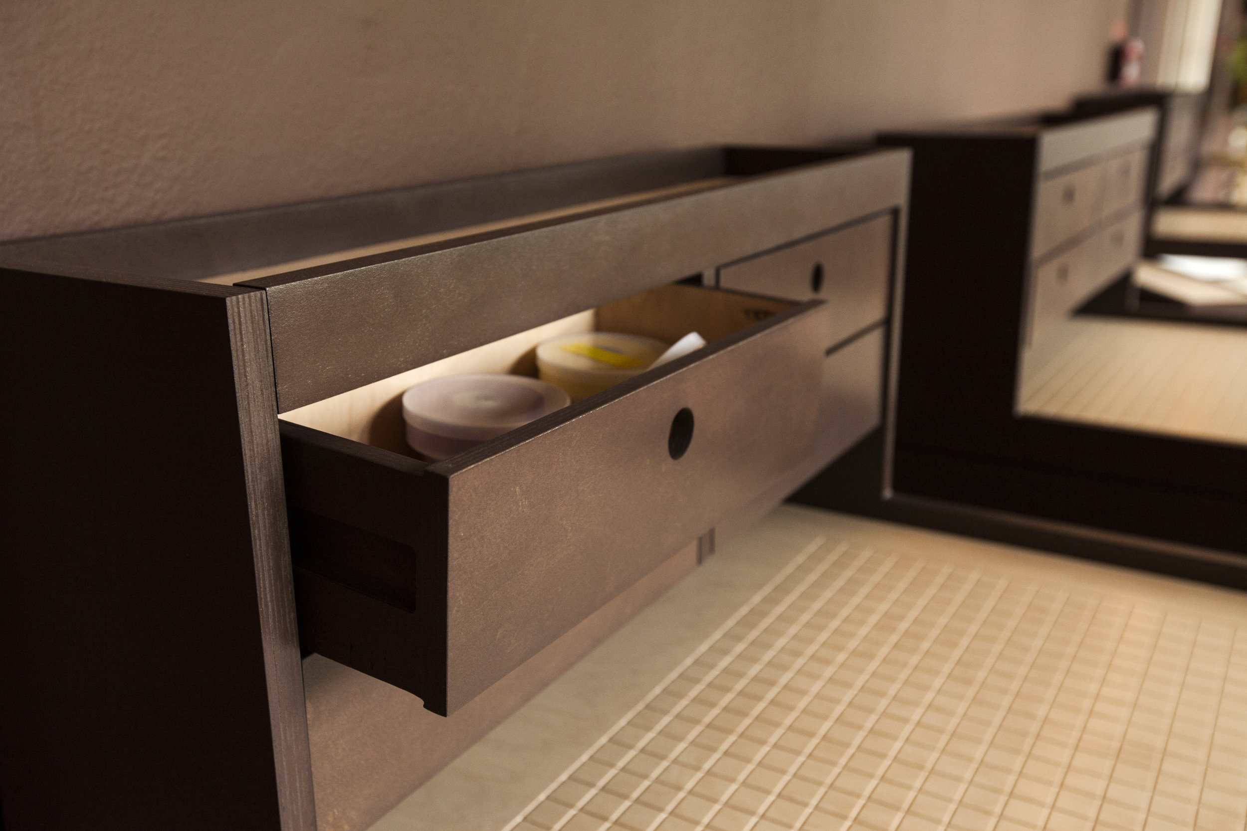  Simple all wood glide drawers reference the architectural time period of the building. 