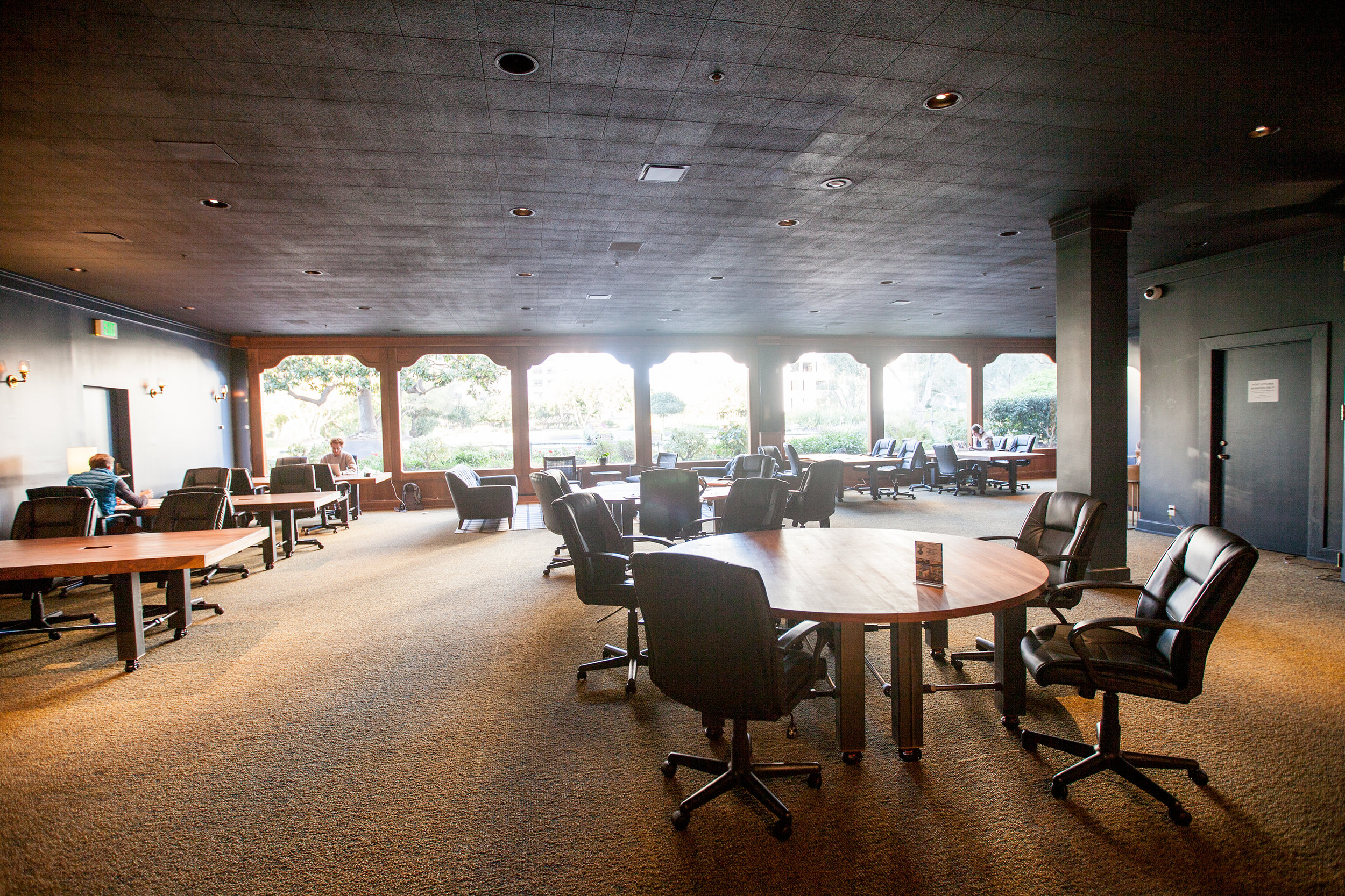  The third floor of the Co-Working space looks out onto a tree filled roof garden. Bright windows light the sea of large worktables created for this room. 