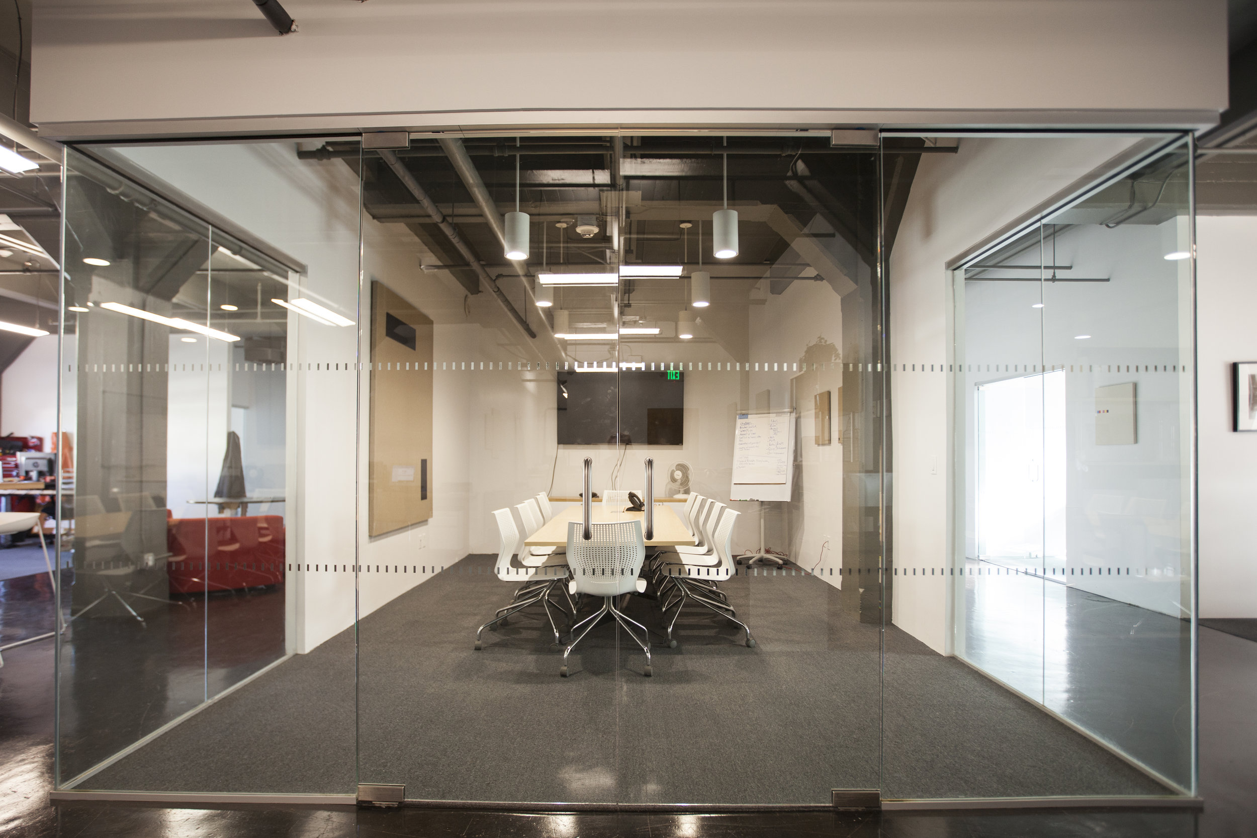  The walls were replaced with glass to open the space with light and create space within the office. 