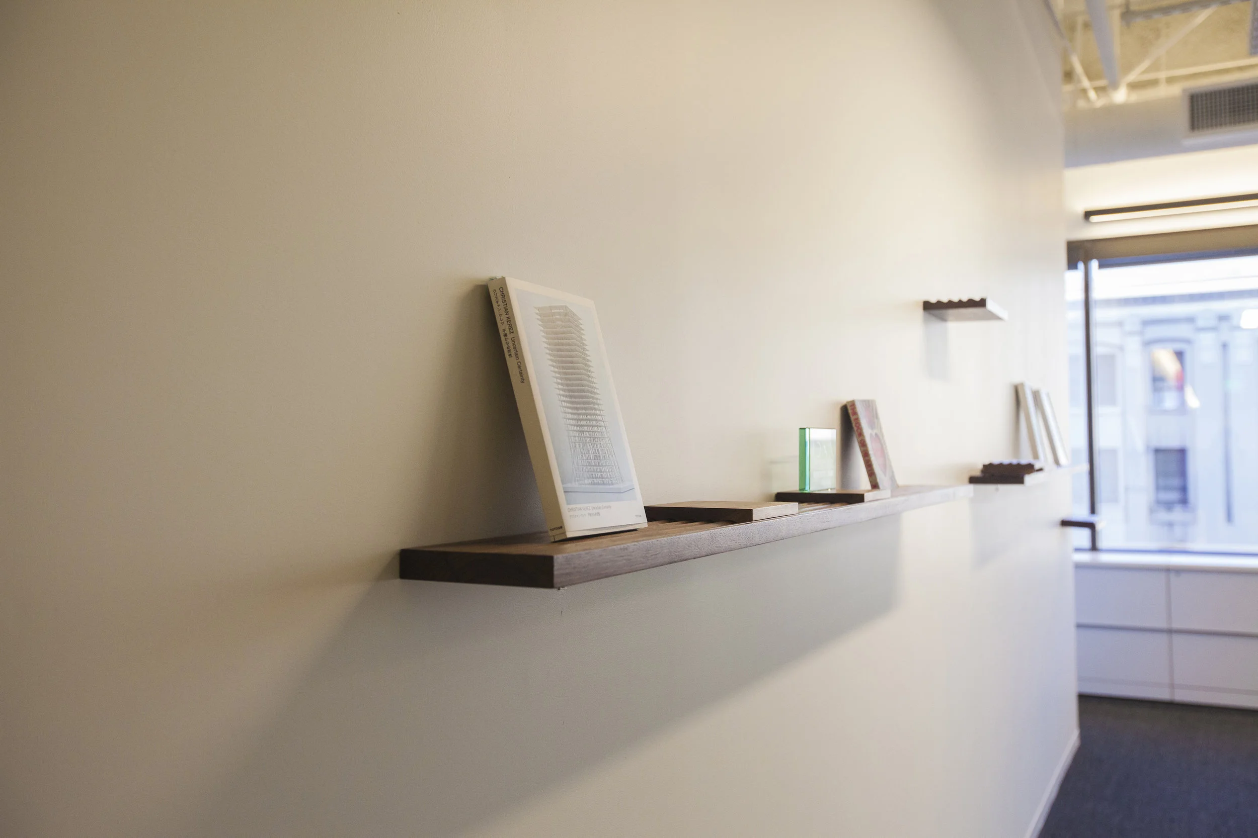 Beginning the layout, the cantilevering shelves arranged decoratively along the wall. 