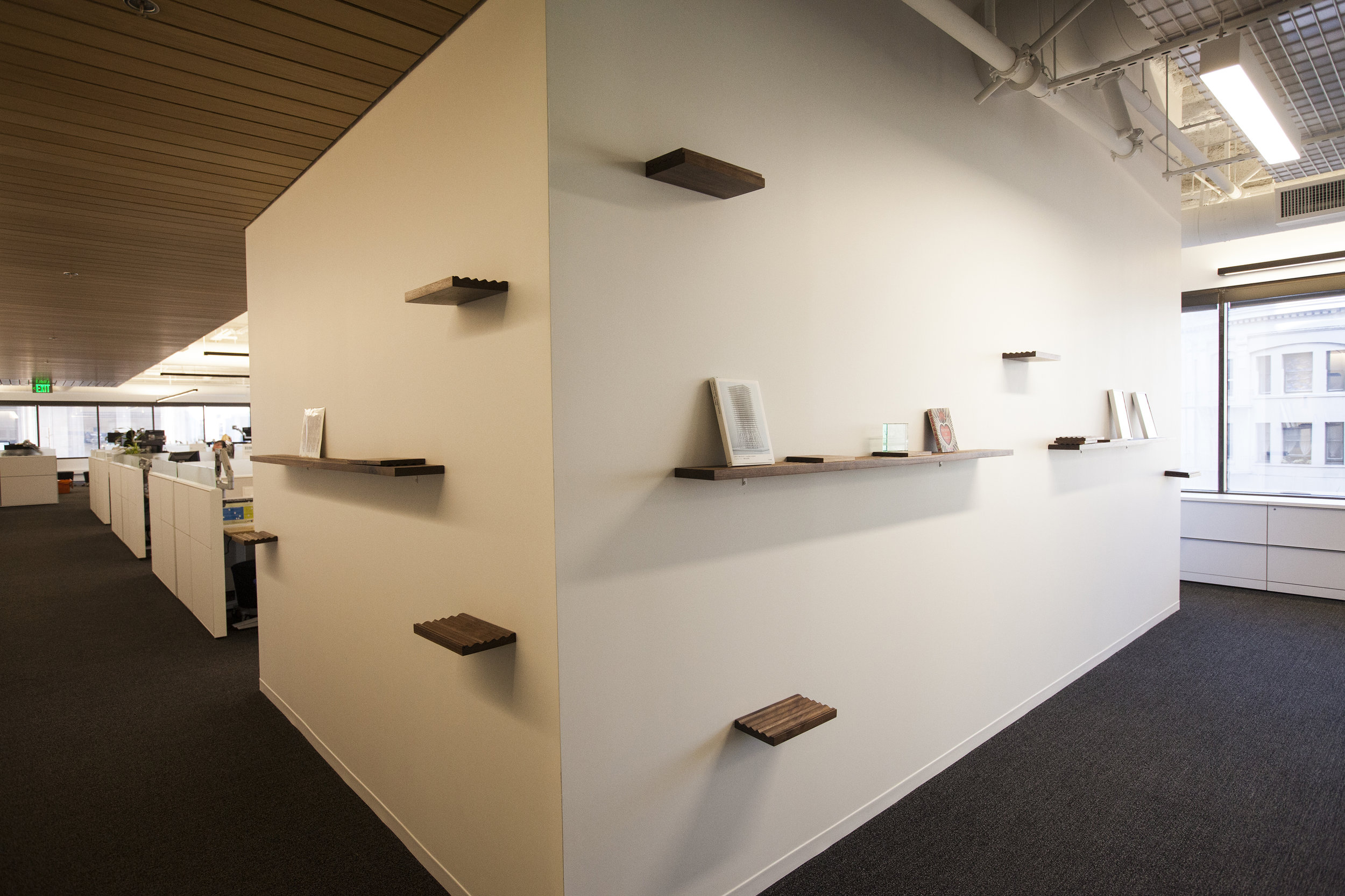  The shelves wrap the corners on both sides of this wall, and allow for fun display of their press materials and awards. 