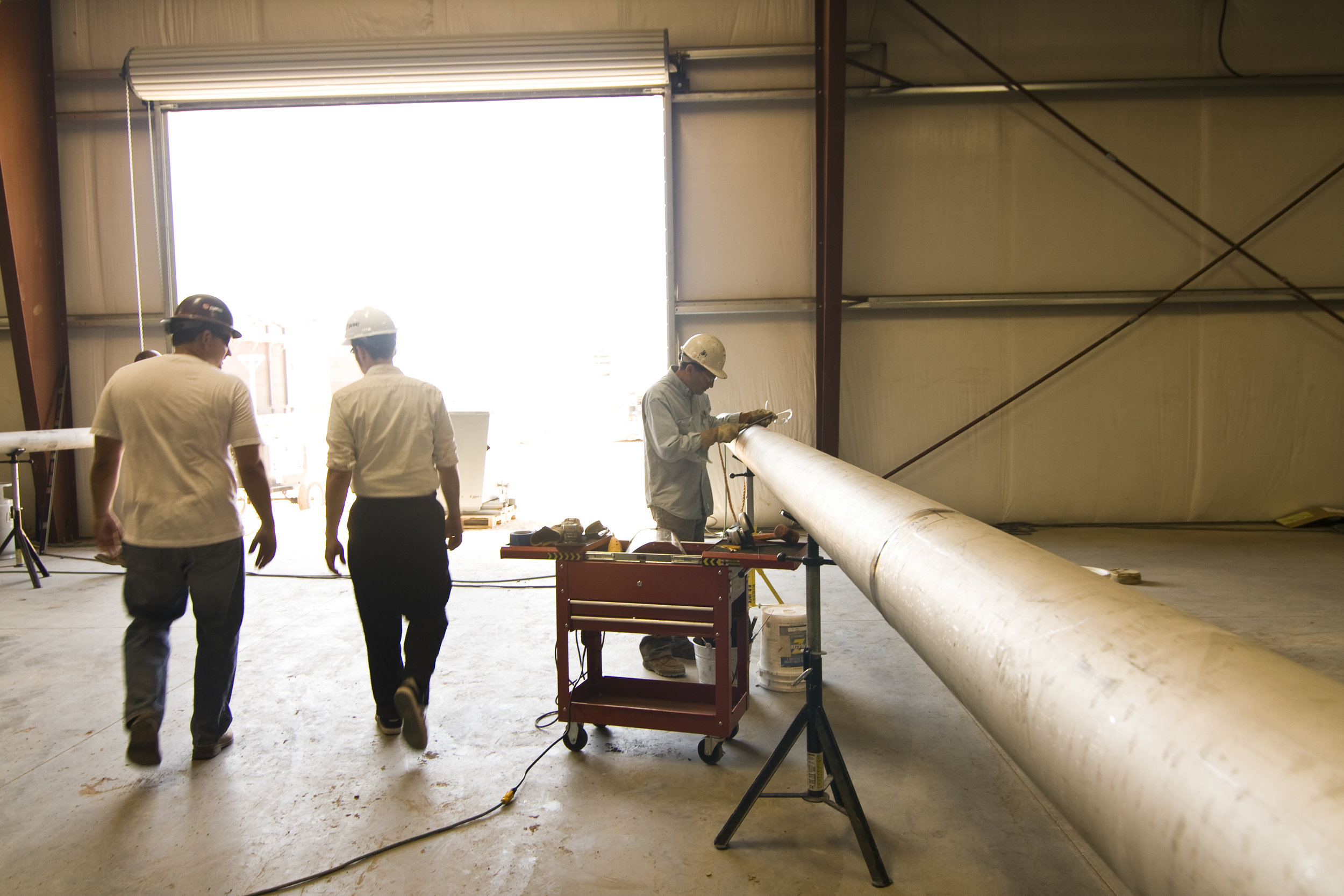  Large doors bring lots of sun into the space. In this back part of the warehouse, workers fabricate specialty pipes. 
